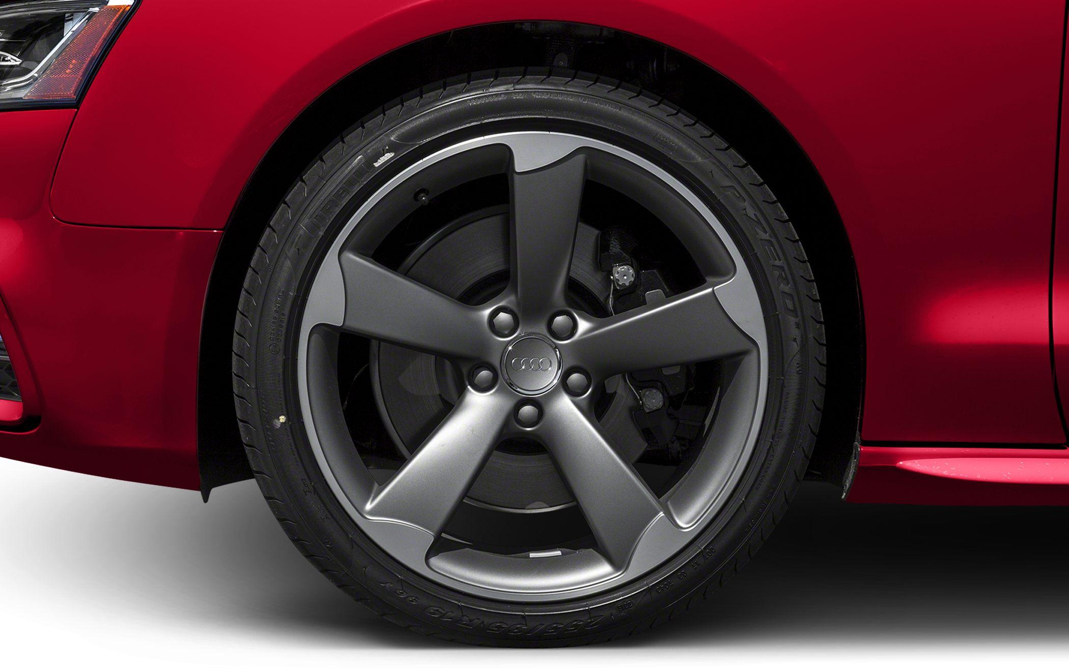 Close-up of 5-spoke alloy wheel and tire on a sports coupe
