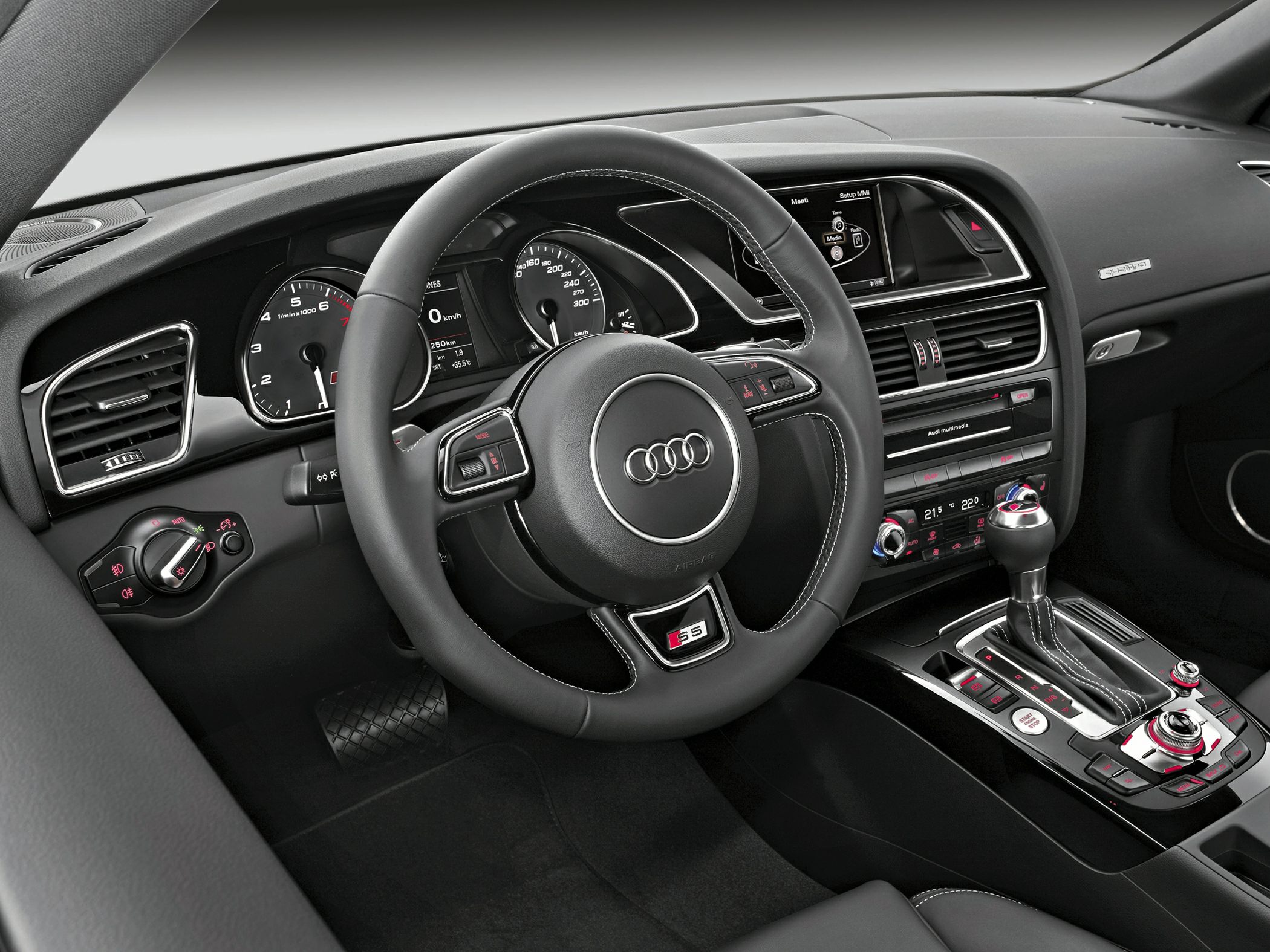 Steering wheel, dashboard cluster, gear shifter, and control panel interior elements