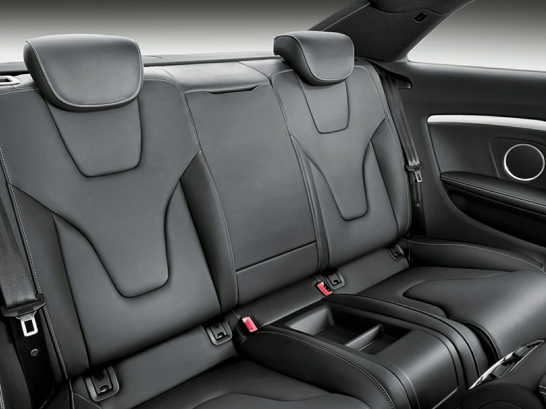 Rear black leather seats with headrests and white stitching