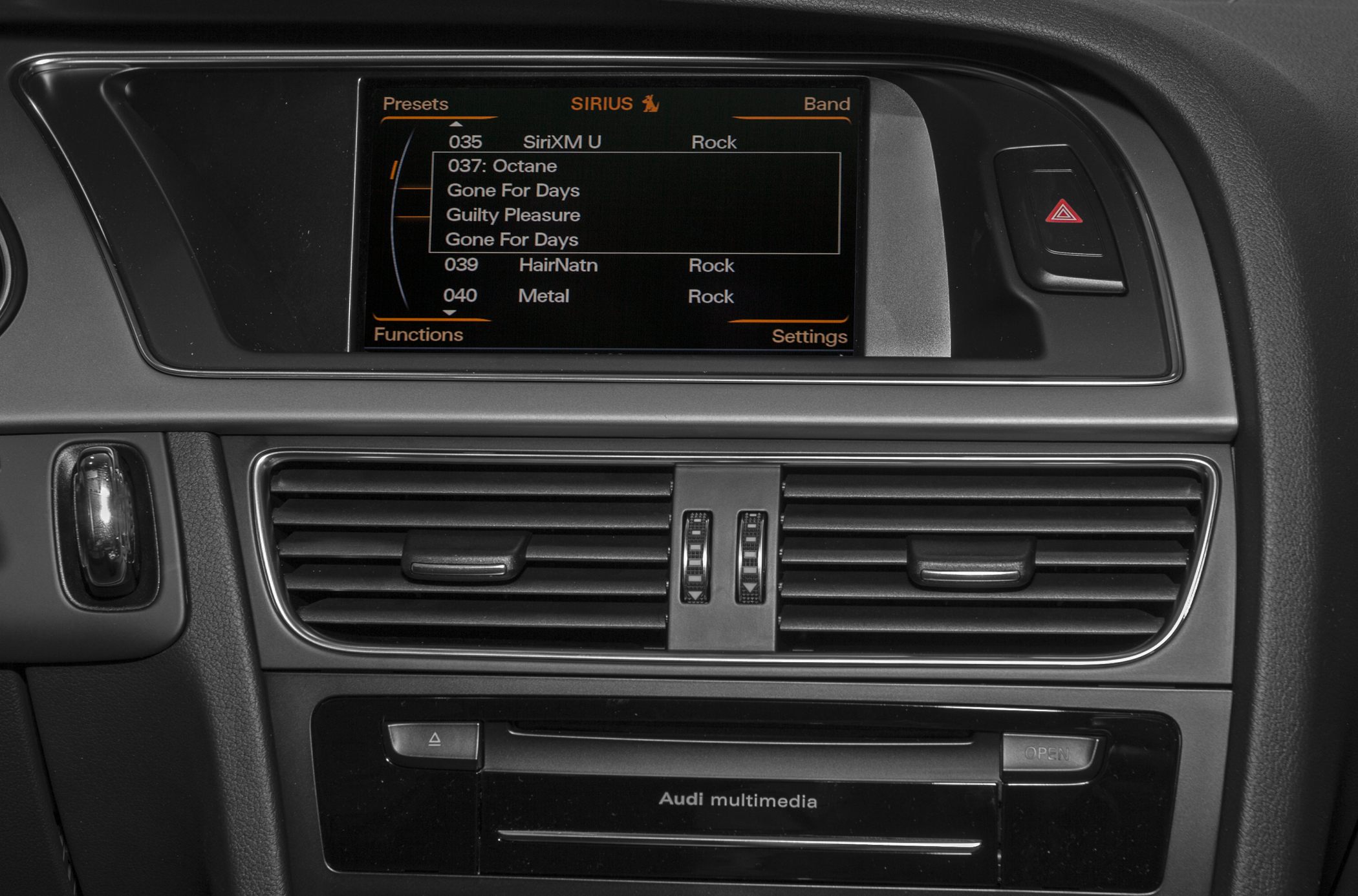 Infotainment screen and central air vents with multimedia controls