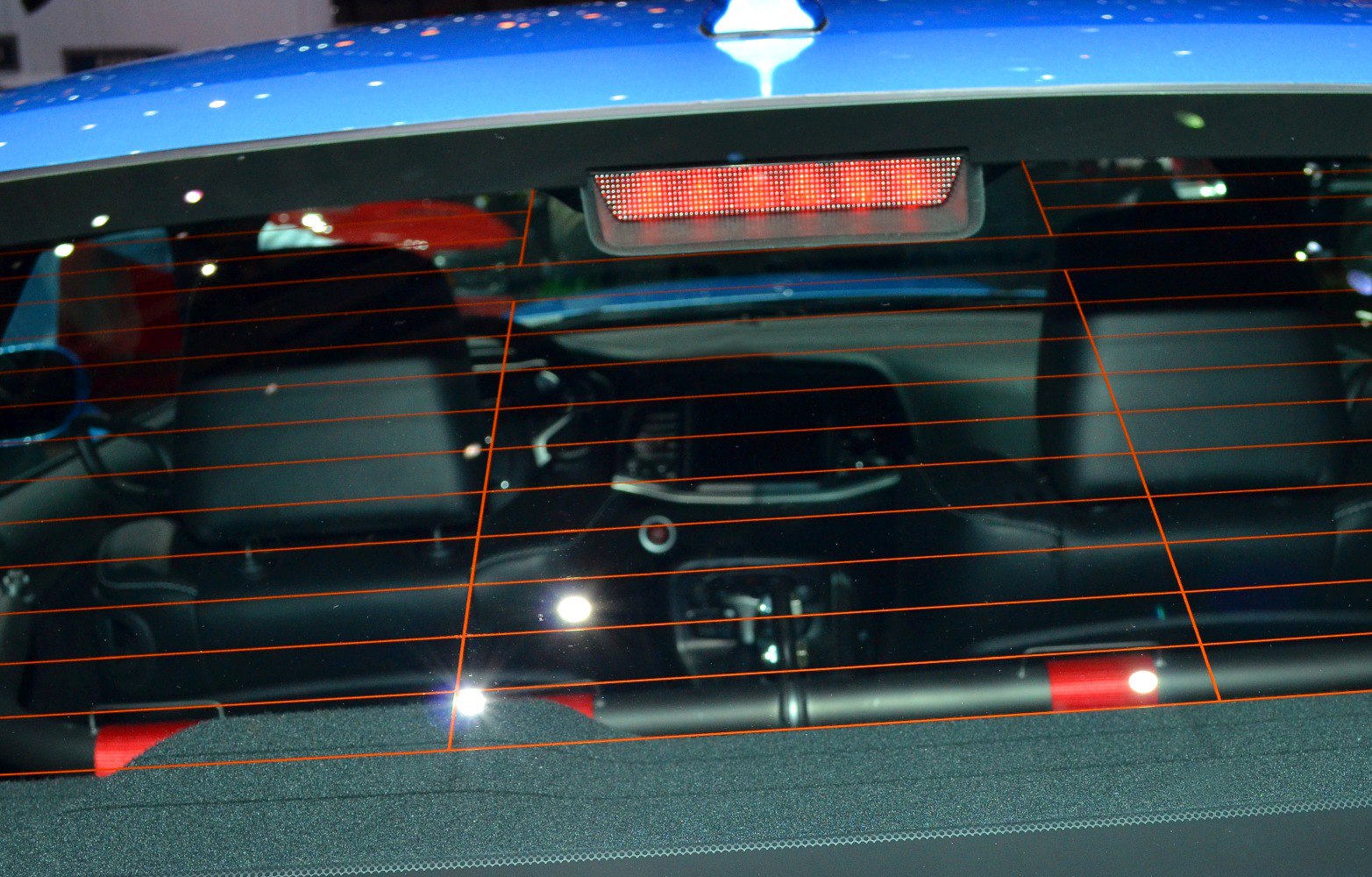 Rear window with orange defroster lines and illuminated third brake light