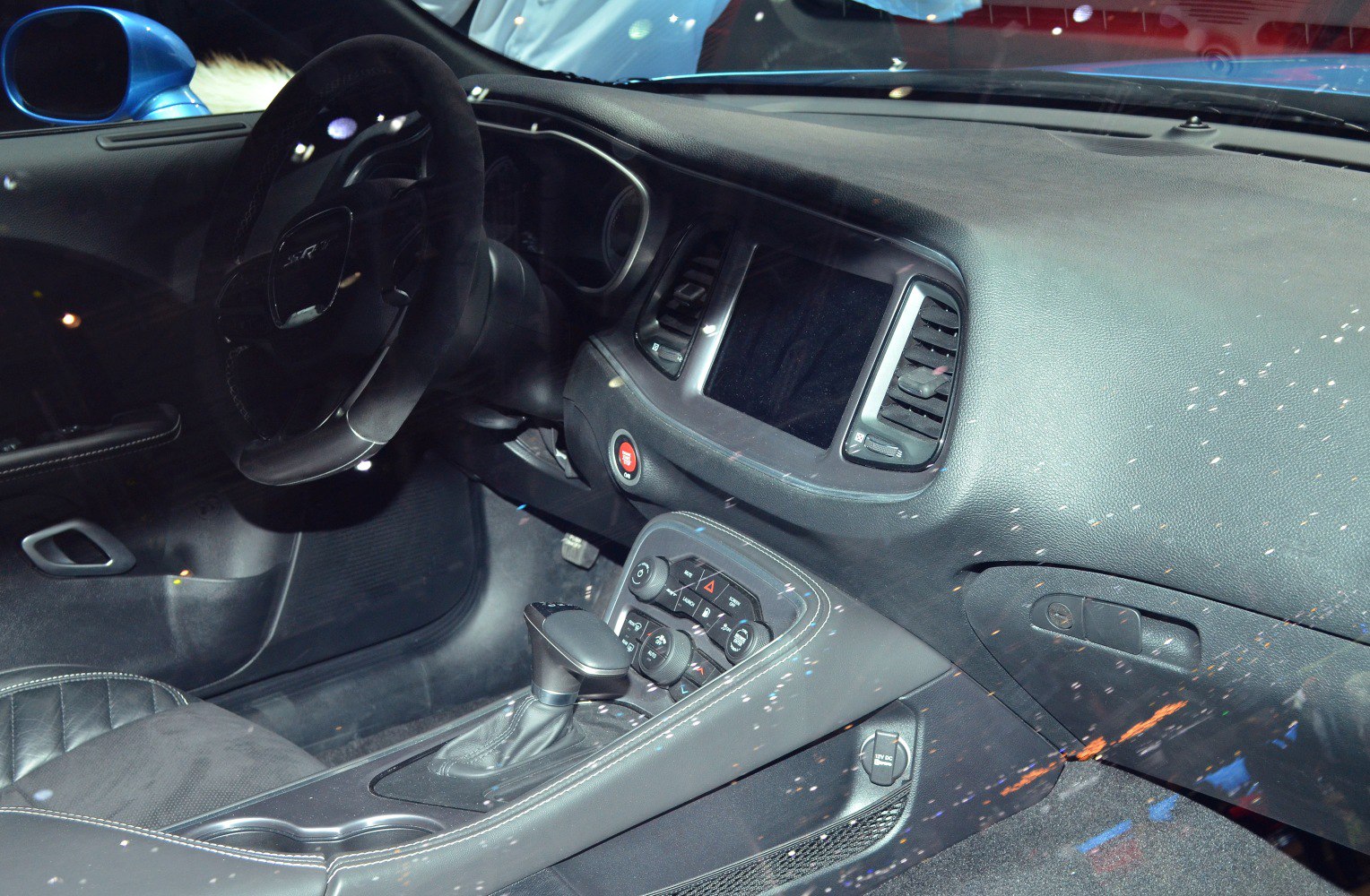 Interior dashboard, steering wheel, gear shifter, and infotainment console.