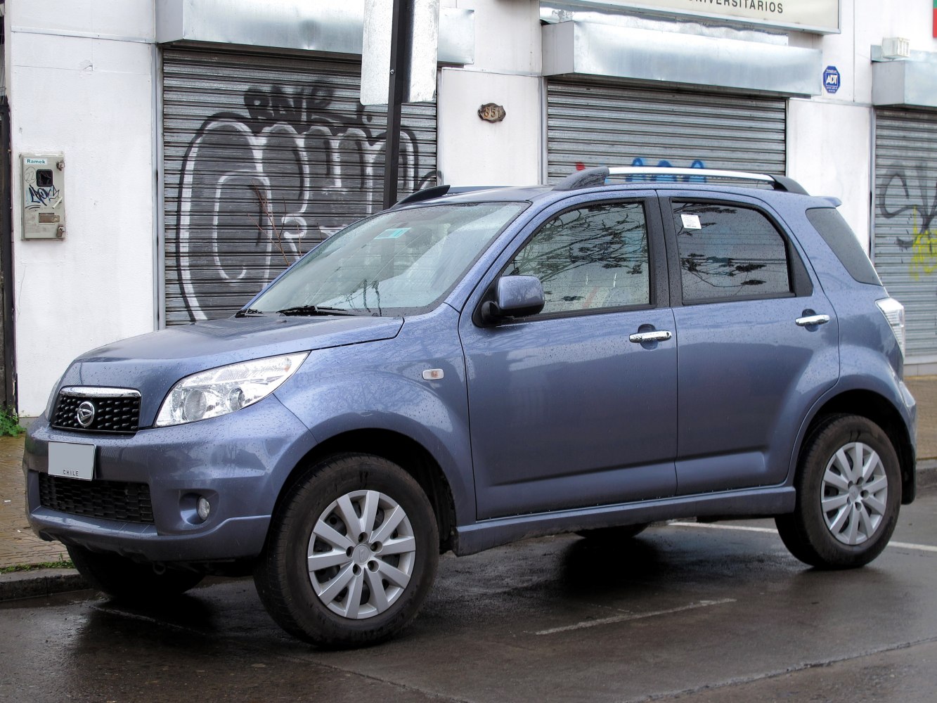 Front-side view of a compact SUV with roof rails and alloy wheels