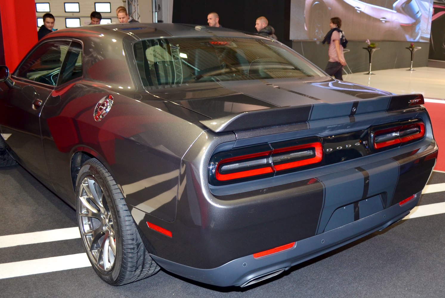 Rear view of a muscle car with distinct tail lights and spoiler