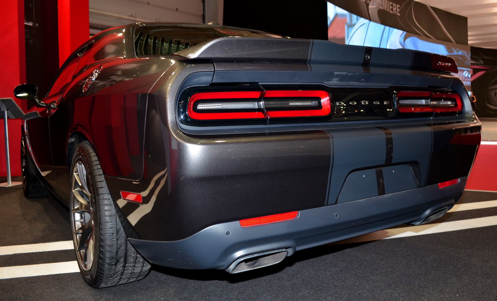 Rear view of muscle car with distinctive taillights and dual exhaust.