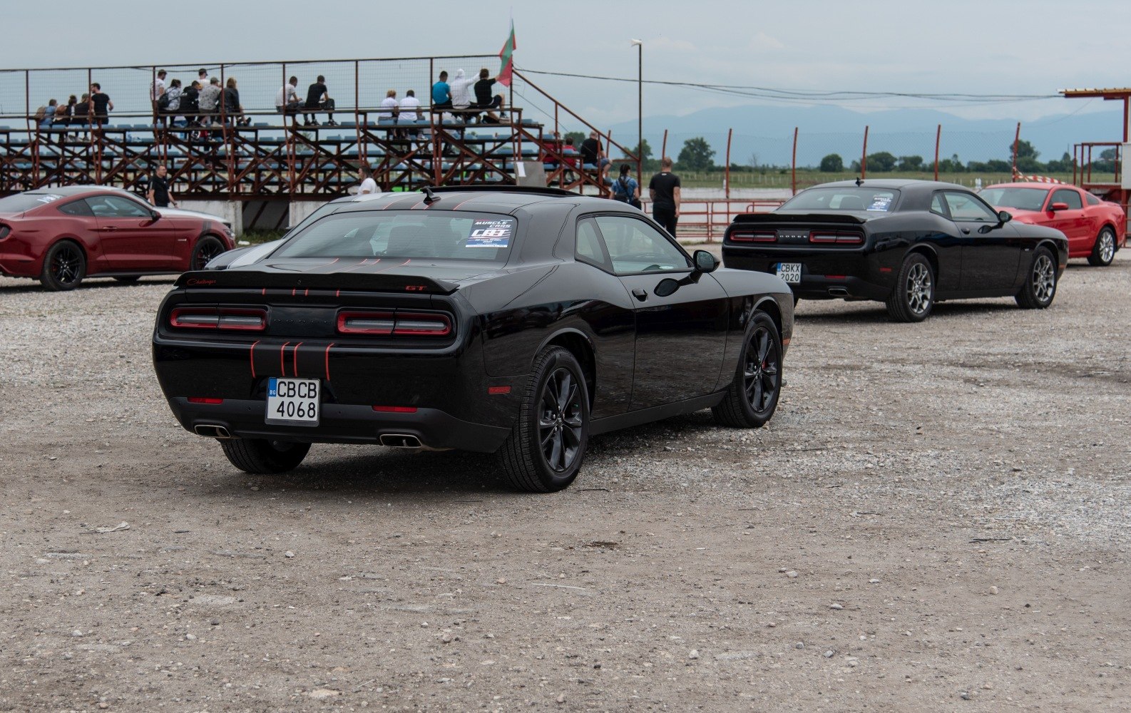 Rear view of a black muscle coupe with dual exhaust and distinctive taillights