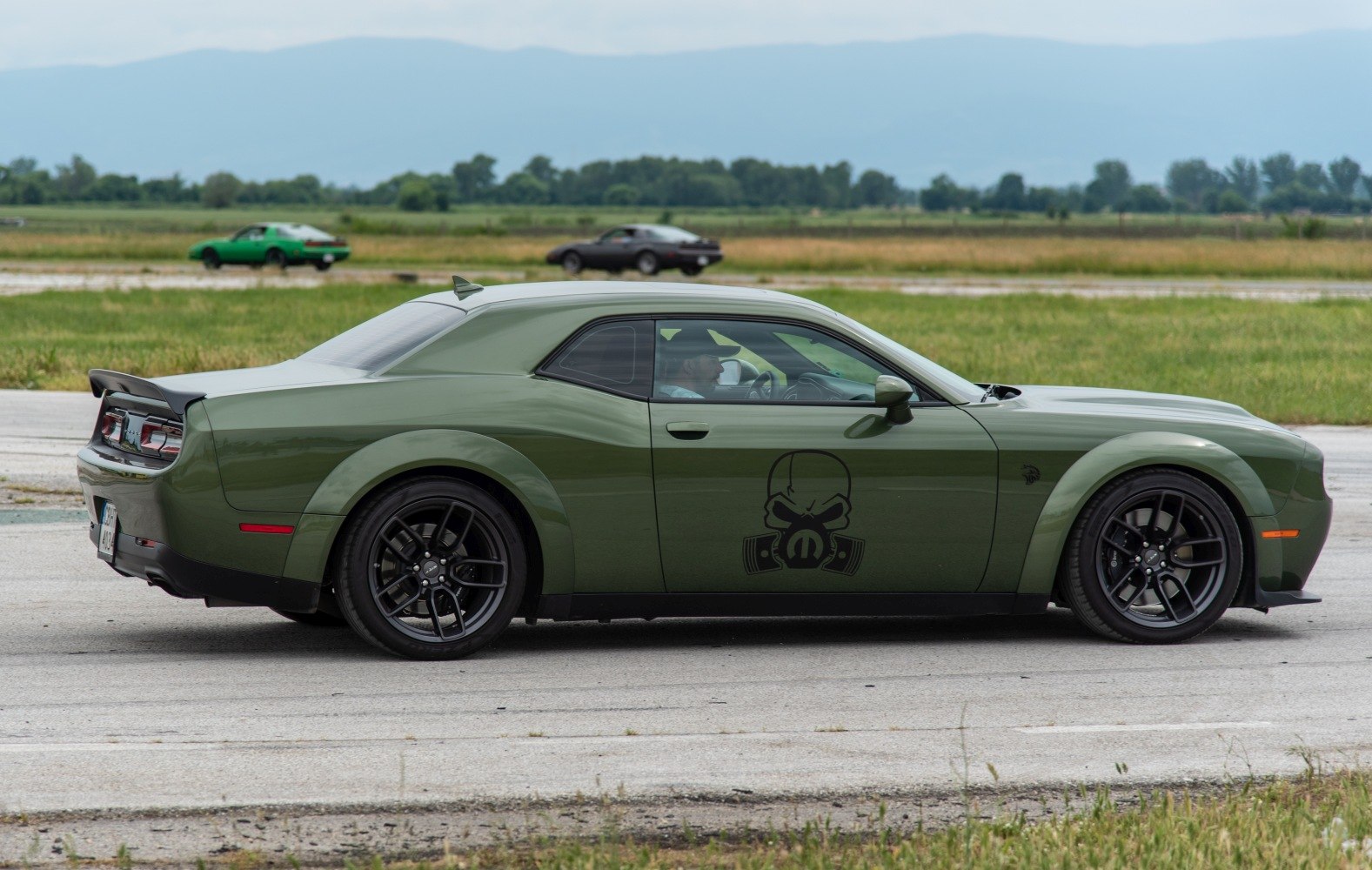 Muscle coupe side view with rear spoiler and custom door decal