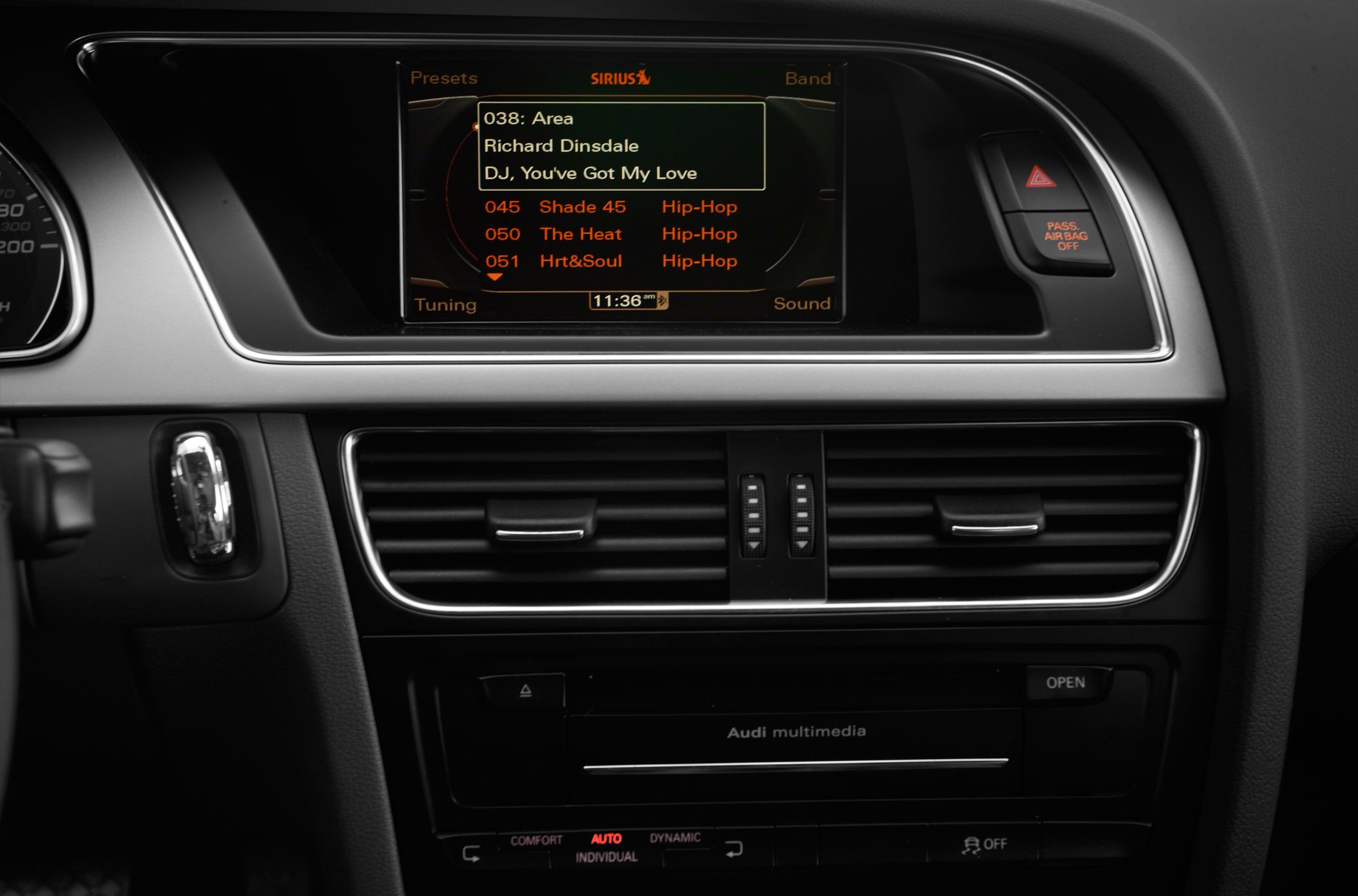 Central multimedia display with radio presets and dual air vents