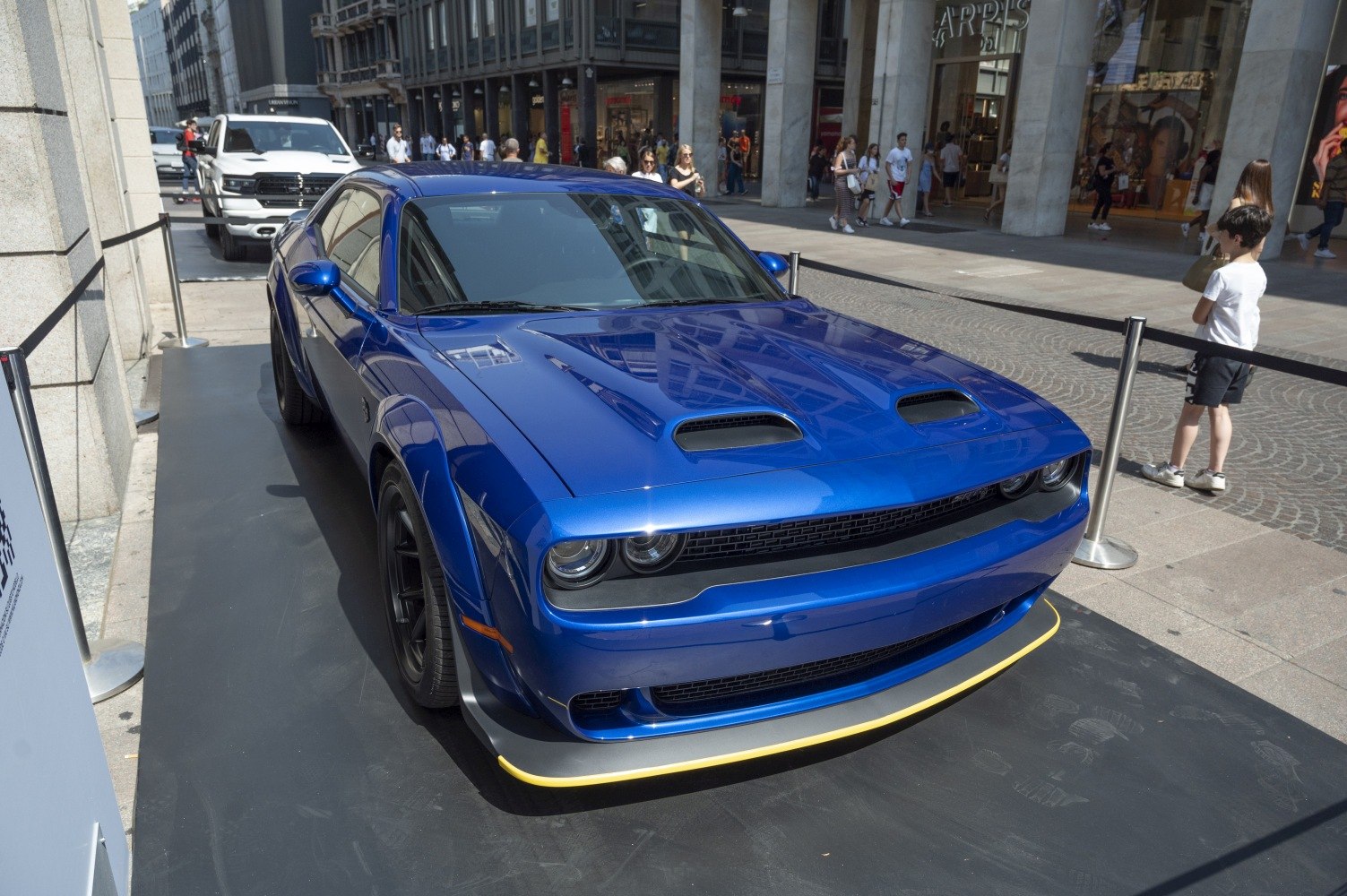 Front and side view of a blue muscle coupe with hood vents and wide stance