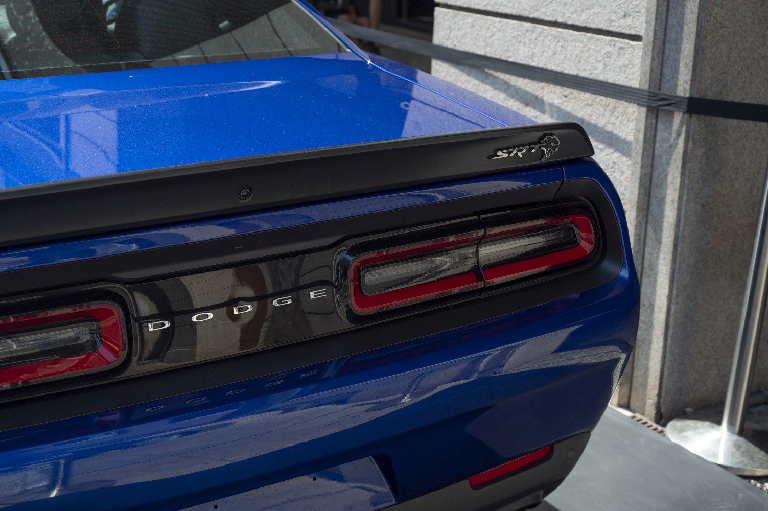 Rear taillights and SRT spoiler on a blue muscle car
