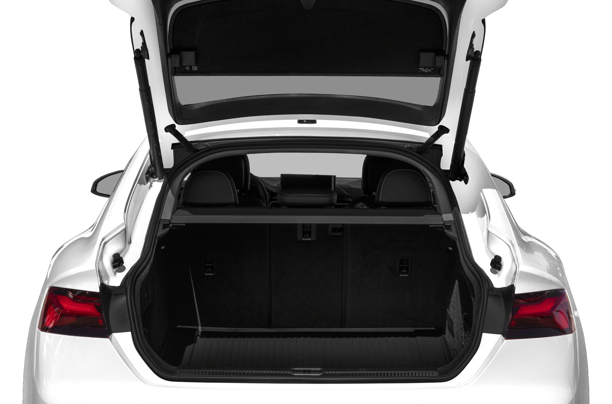 Rear trunk interior of a modern white sedan with spacious cargo area.