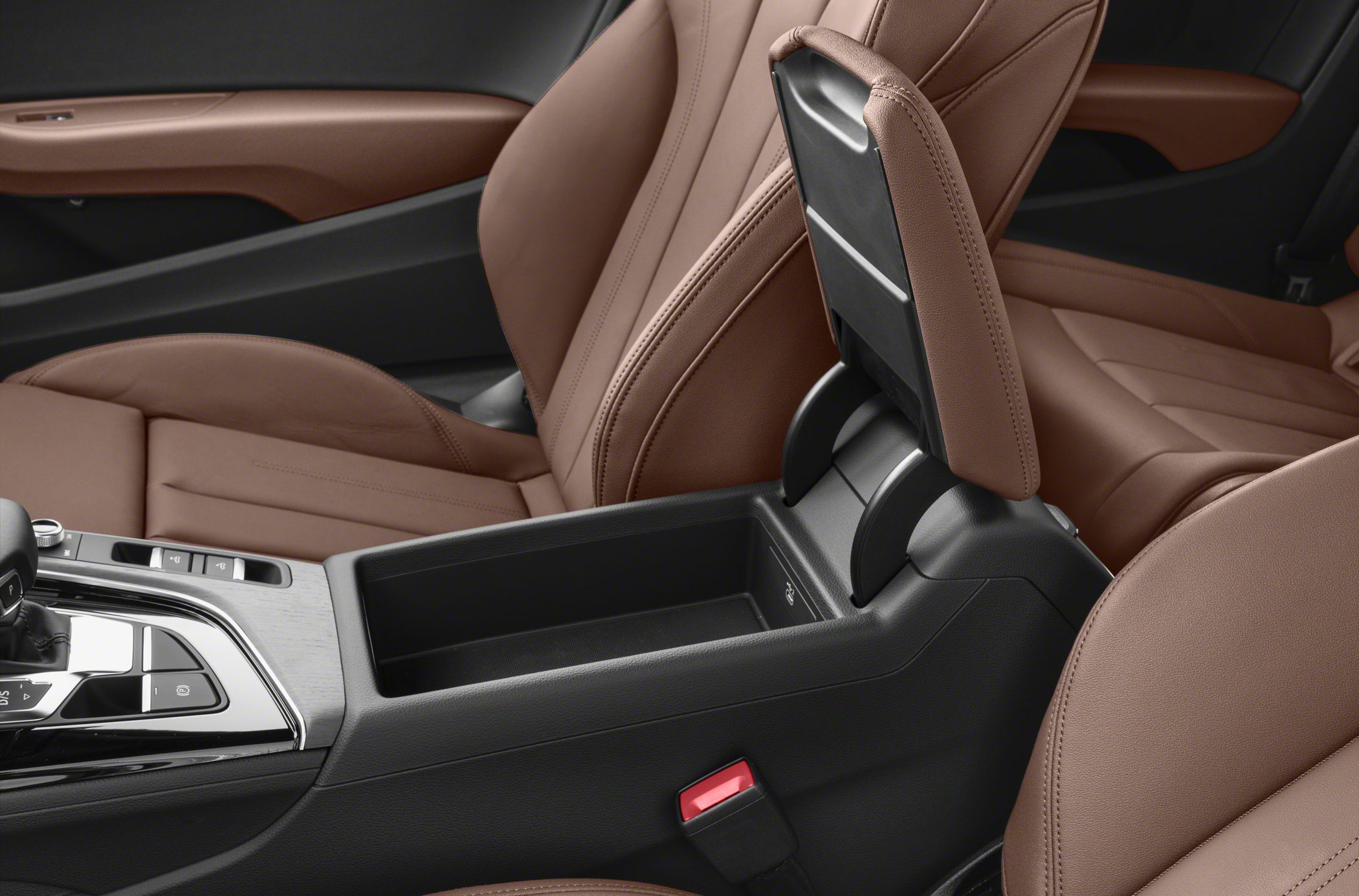 Open center console storage and brown leather seats with armrest