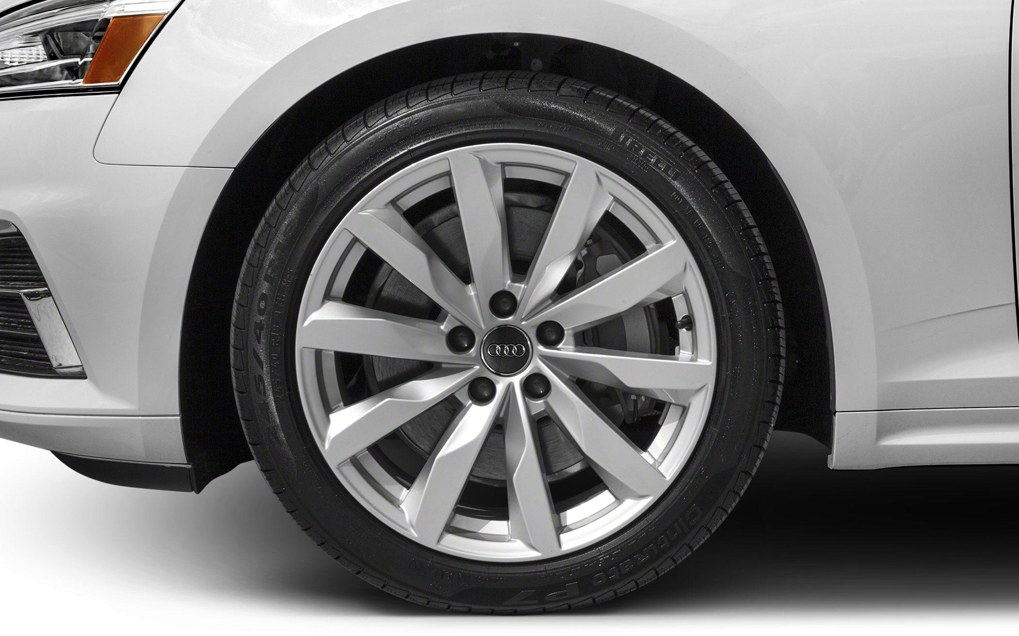 Close-up of a 10-spoke alloy wheel on a car's front fender.