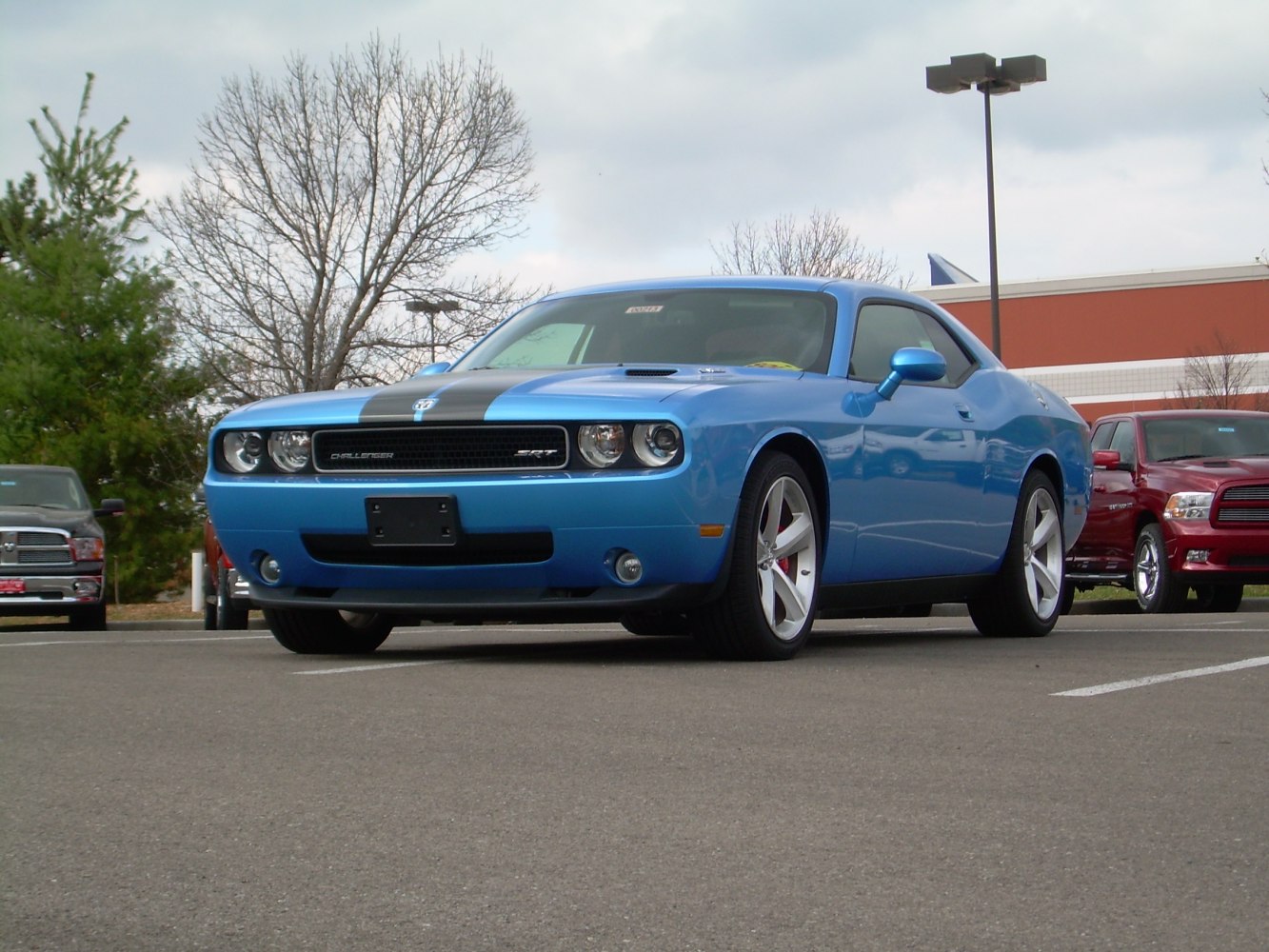 Front angled view of blue muscle coupe with black racing stripes