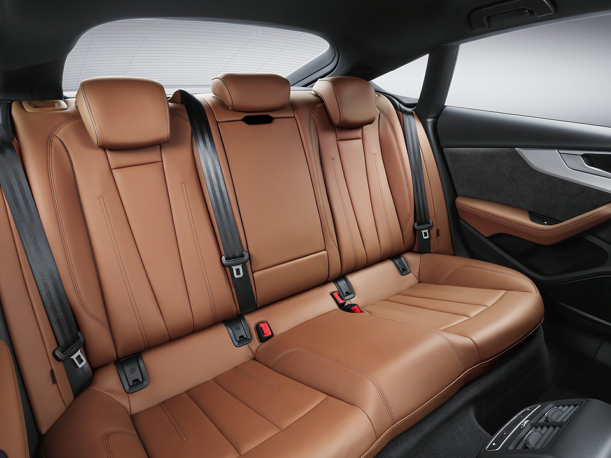 Brown leather rear seats with headrests and seatbelts
