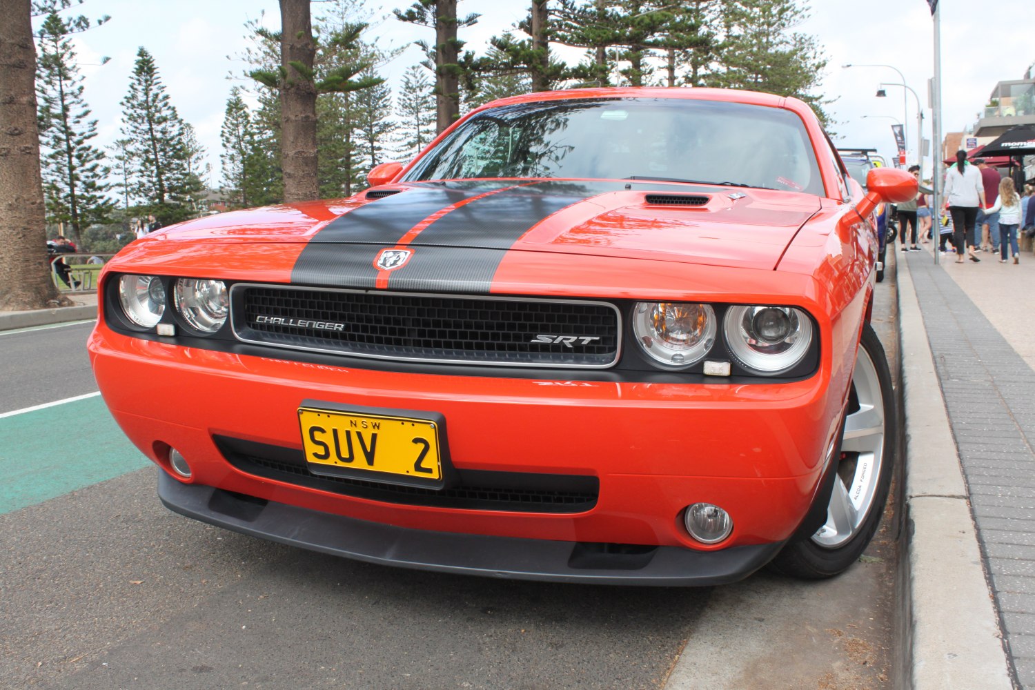 Front grille, black hood stripe, and SRT badge on muscle car