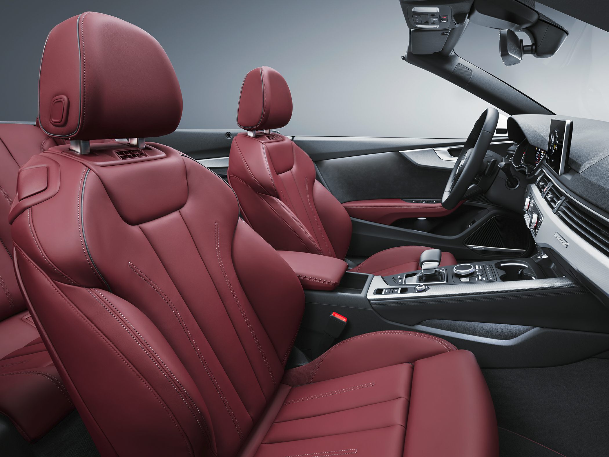 Burgundy leather seats with stitching and modern dashboard layout