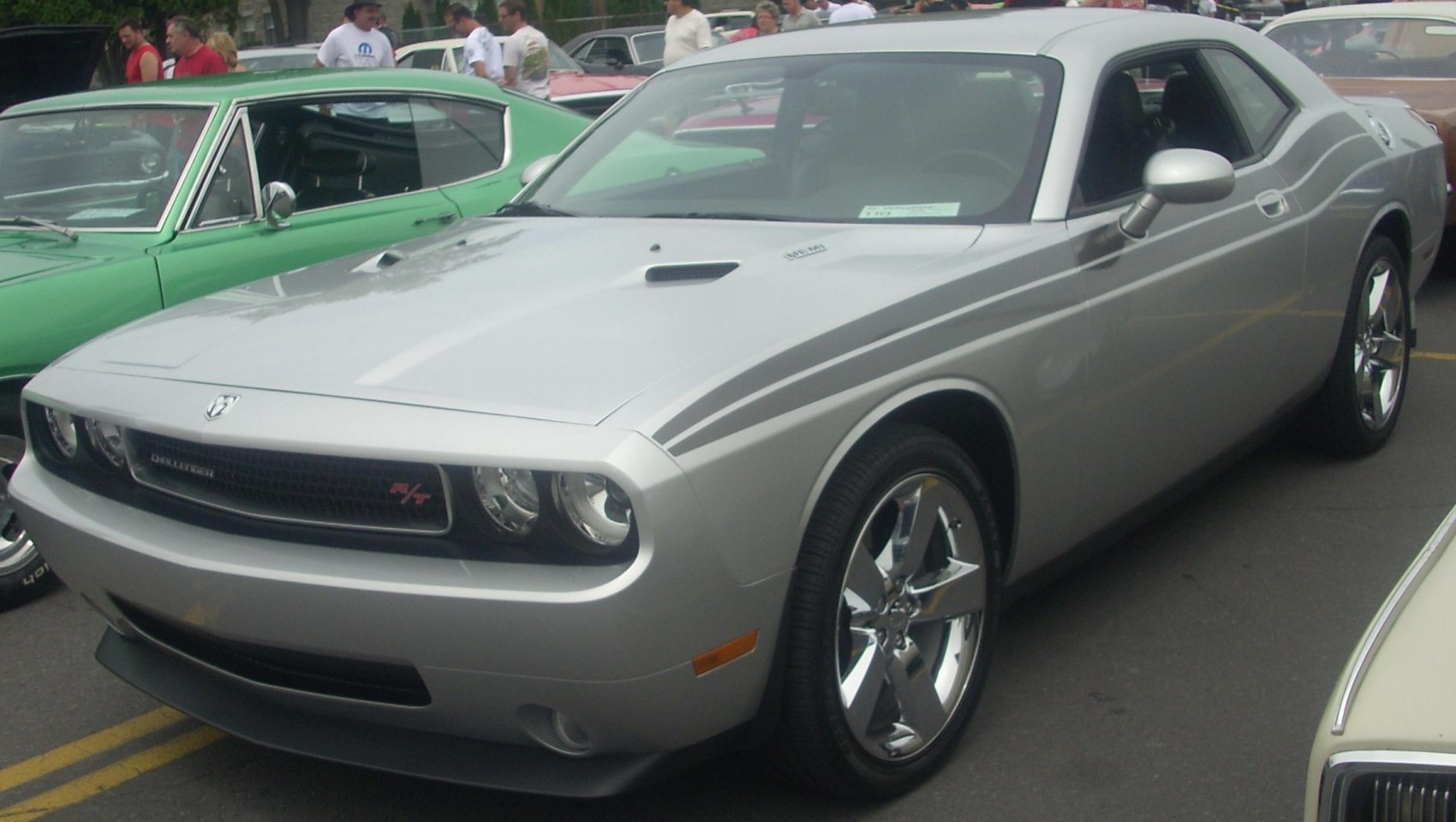 Silver muscle coupe with hood scoop, stripes, and chrome wheels