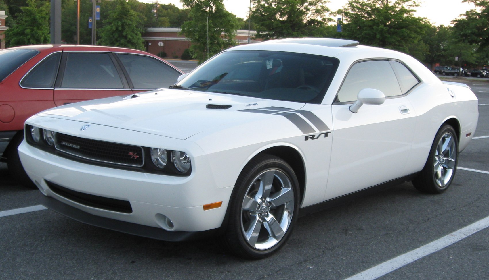 White muscle coupe with hood scoop, R/T badge, and dual stripes