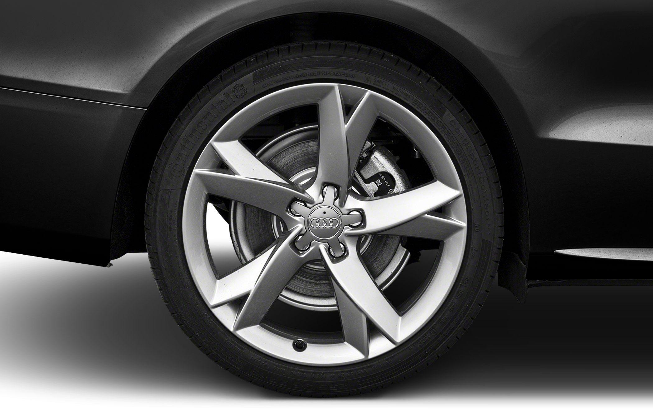 Close-up of 5-spoke alloy wheel with Continental tire and disc brake caliper