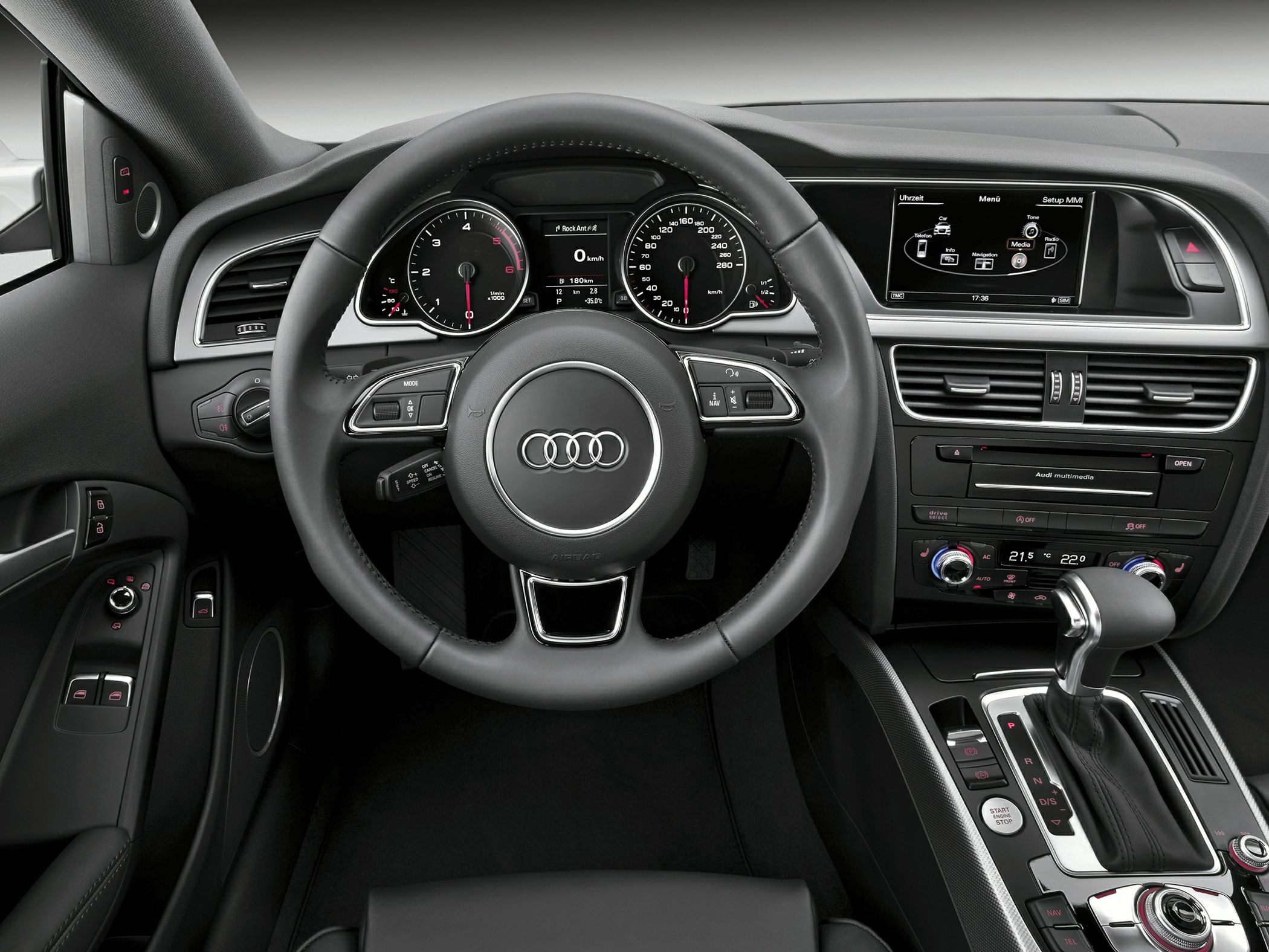 Modern car interior with dashboard, steering wheel, and multimedia display
