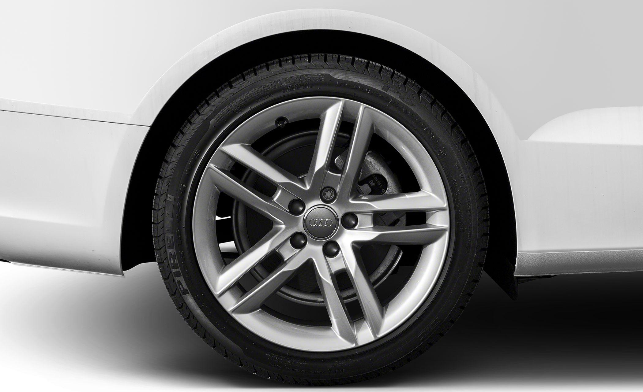 Close-up of alloy wheel with 5-spoke design and tire on white body