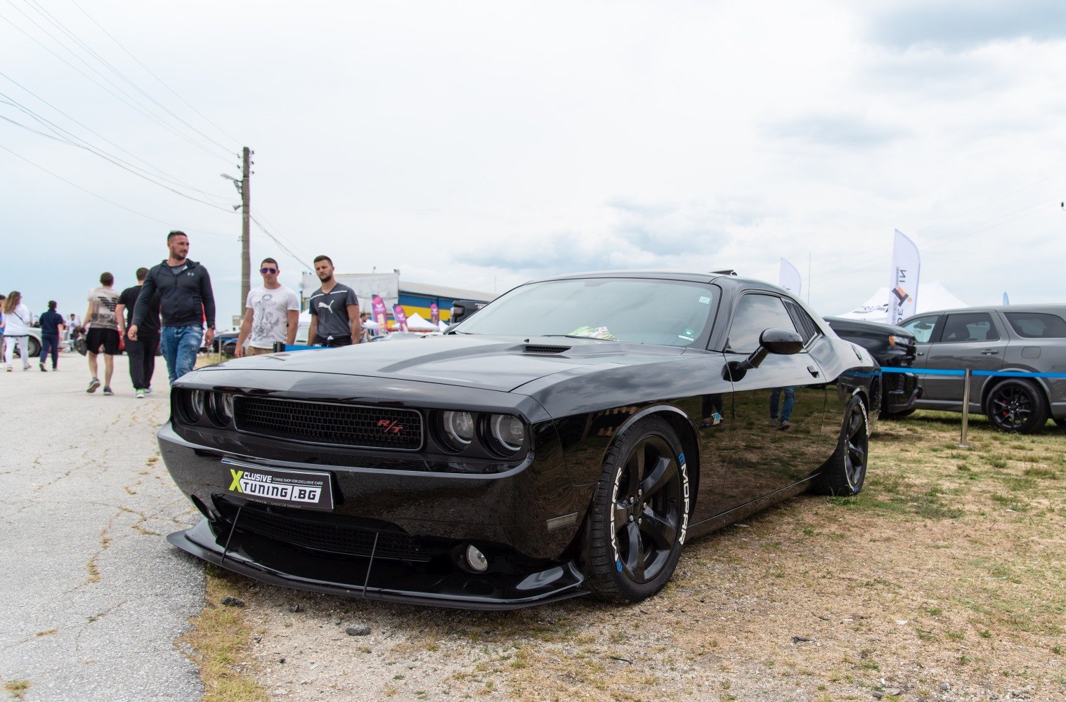 Black muscle car with aggressive front grille and aerodynamic body kit