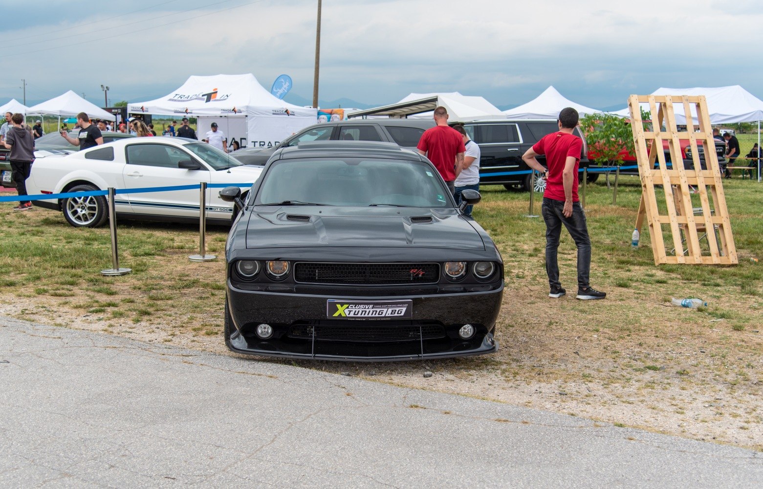 Black muscle car front with hood vents and aggressive grille