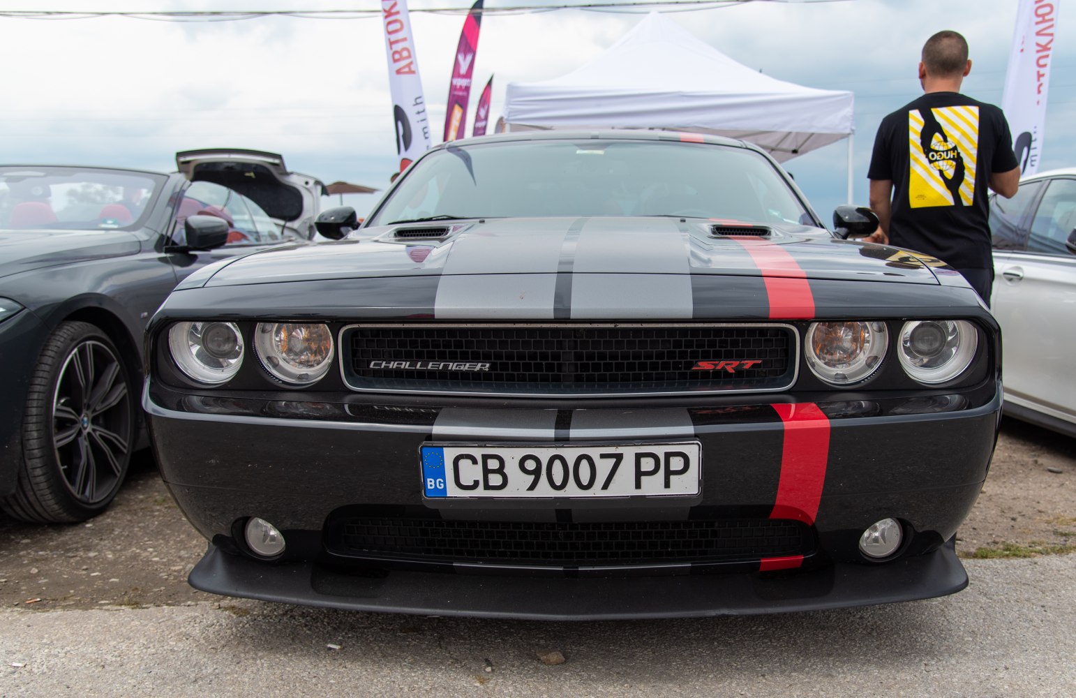 Front view of muscle car with racing stripes and SRT badge
