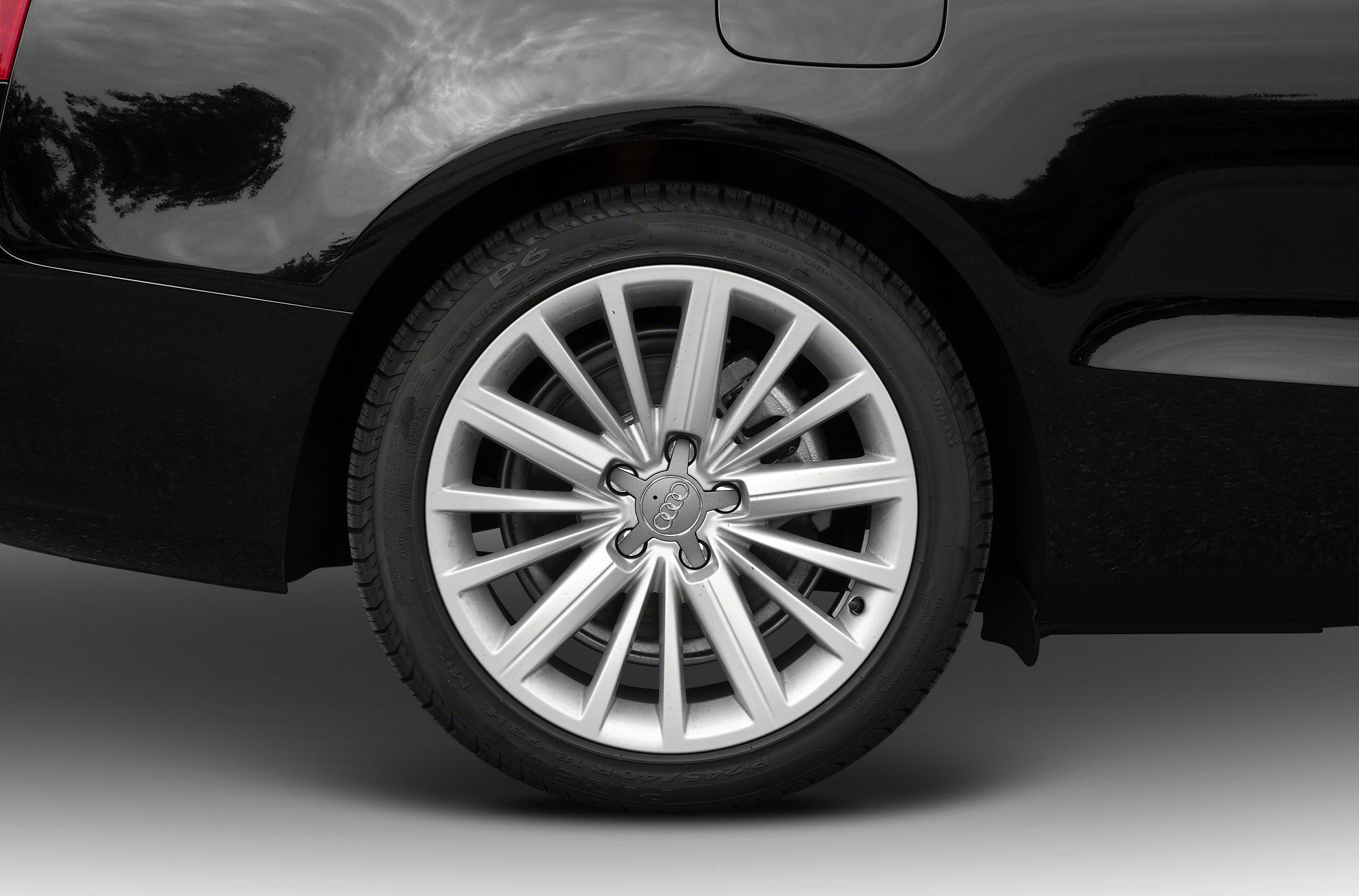 Multi-spoke alloy wheel and tire close-up from a black vehicle