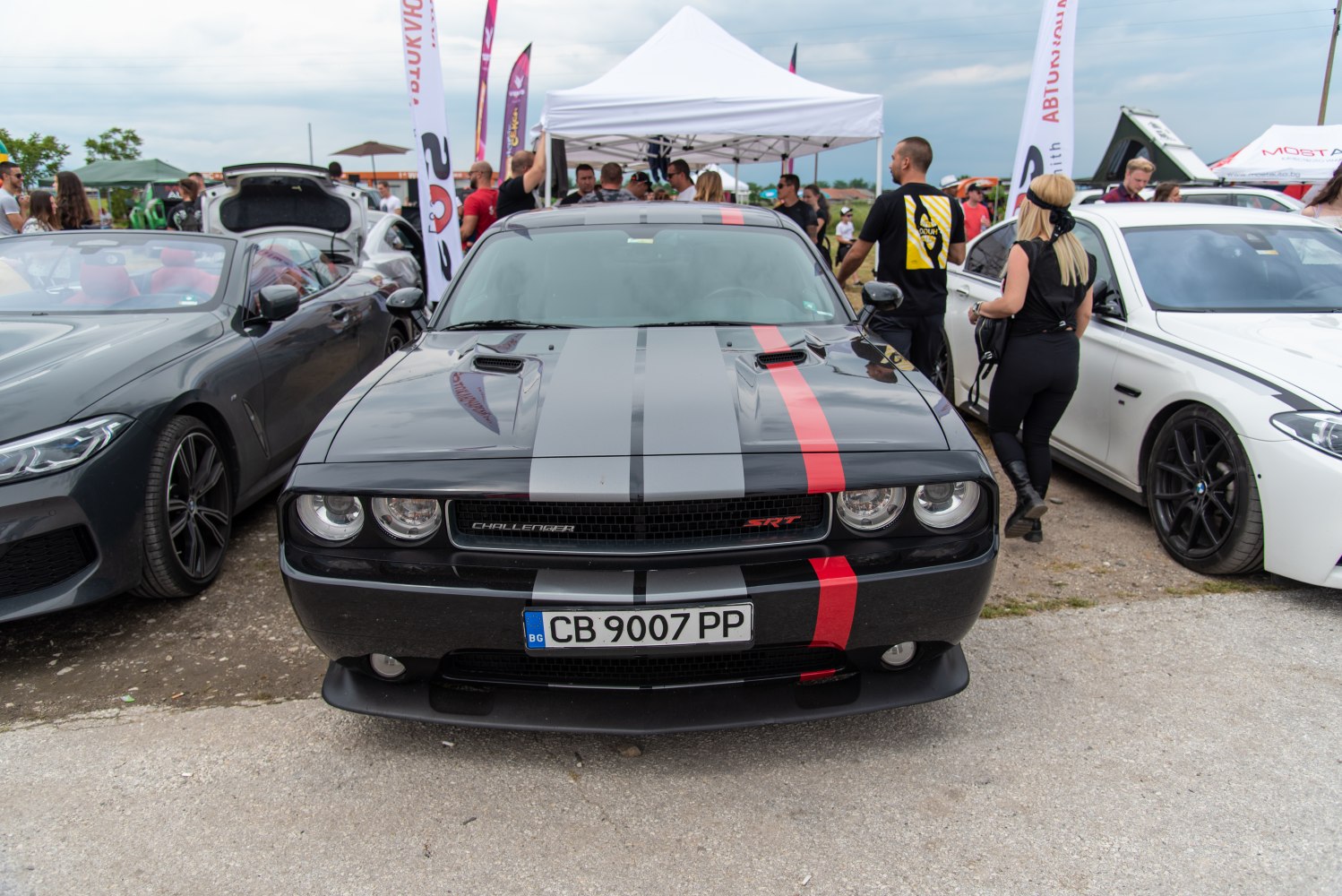 Front view of muscle car with dual racing stripes and hood vents