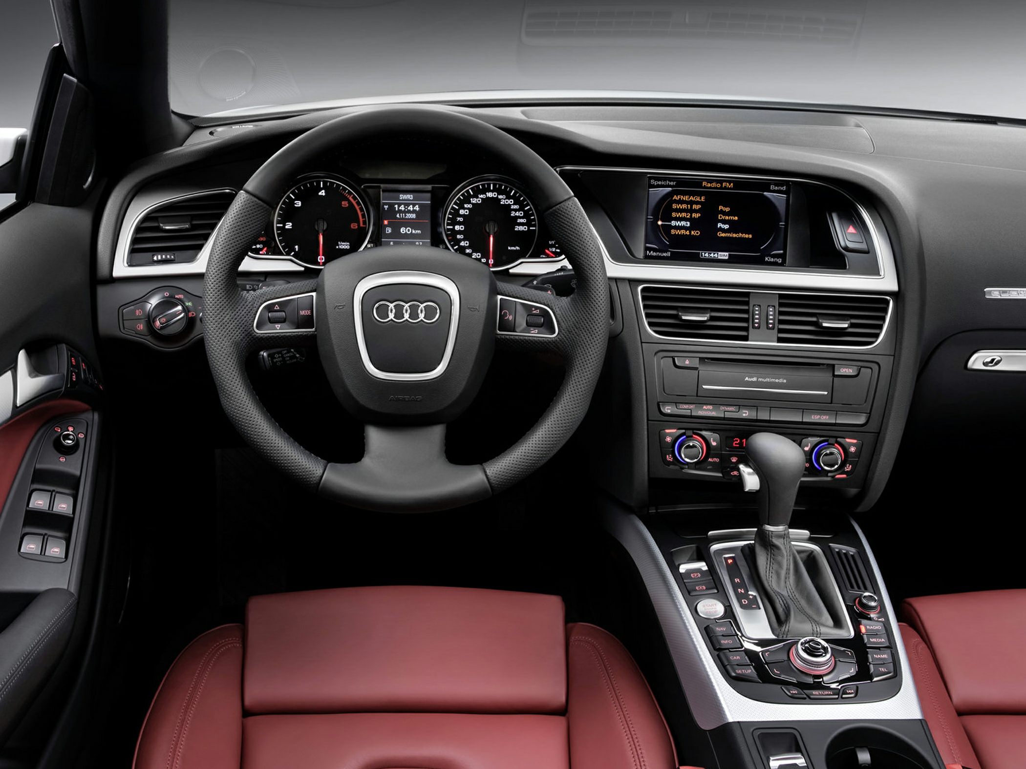 Steering wheel, instrument cluster, and center console with multimedia and climate controls
