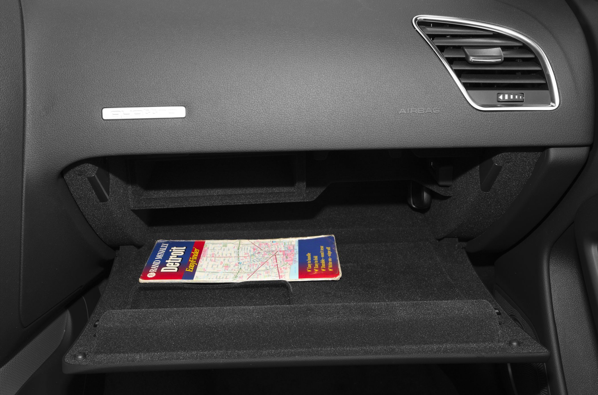 Open glove compartment with map inside