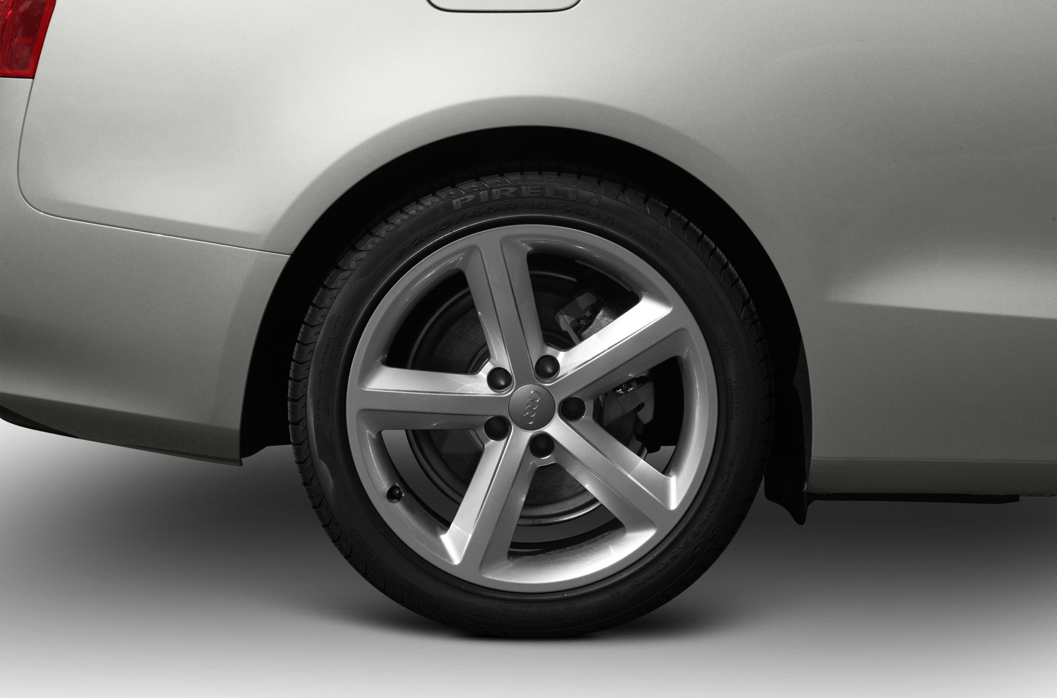 Close-up of rear alloy wheel and tire with brake disc