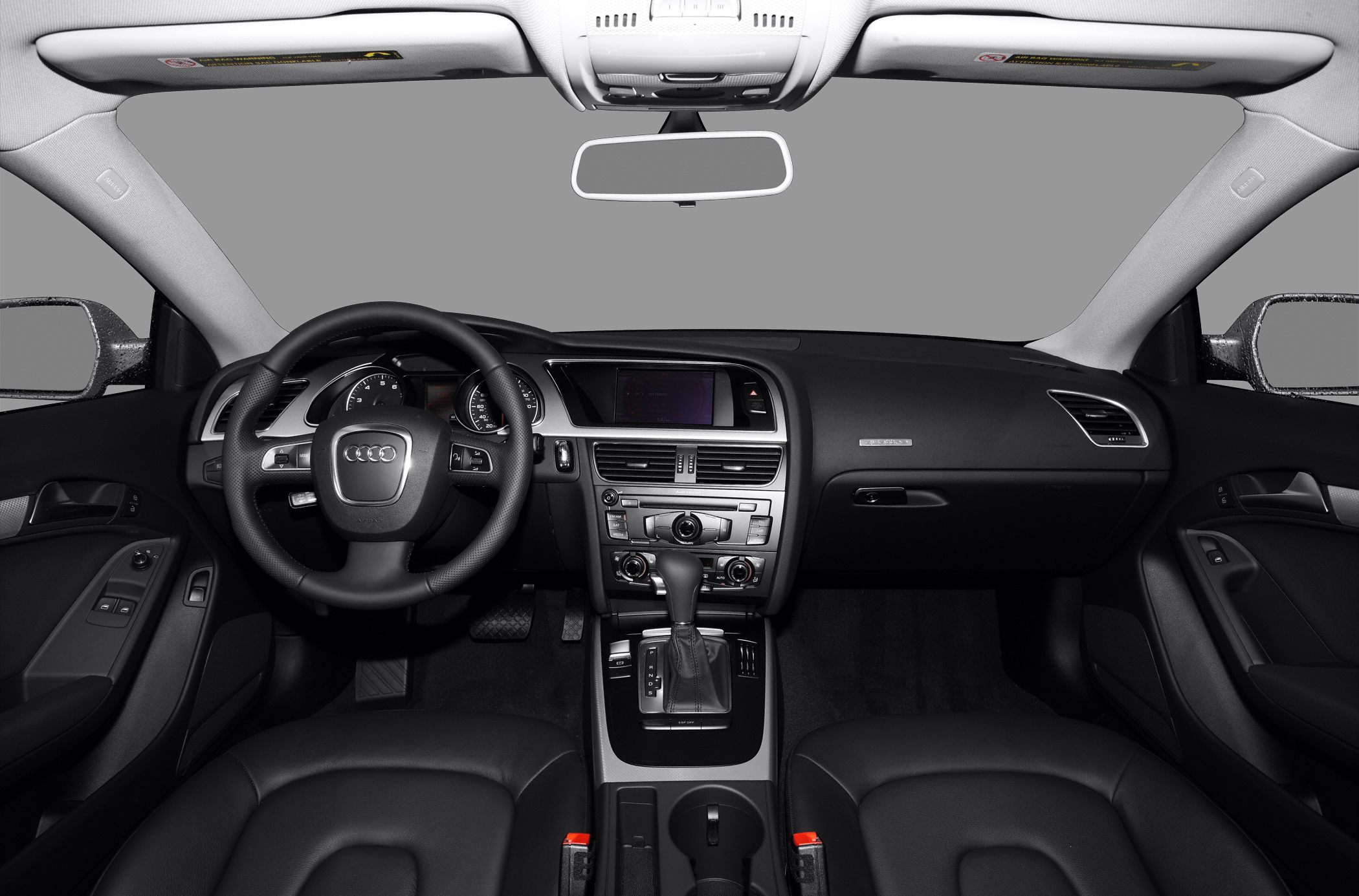 Dashboard and steering wheel with center console controls in black interior