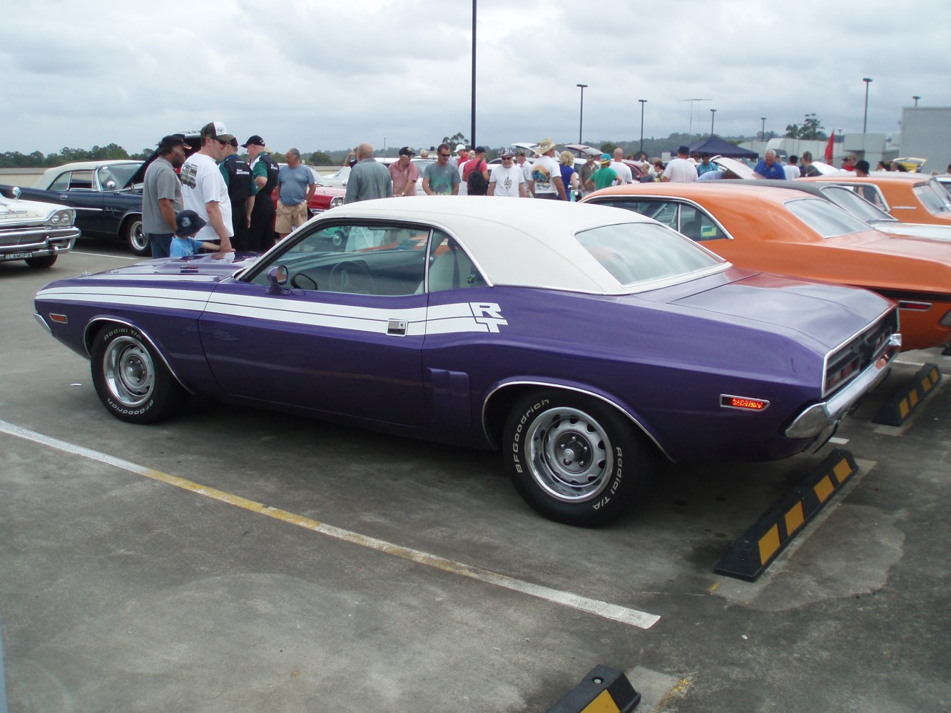 Side view of classic muscle car with R/T stripes and white vinyl roof