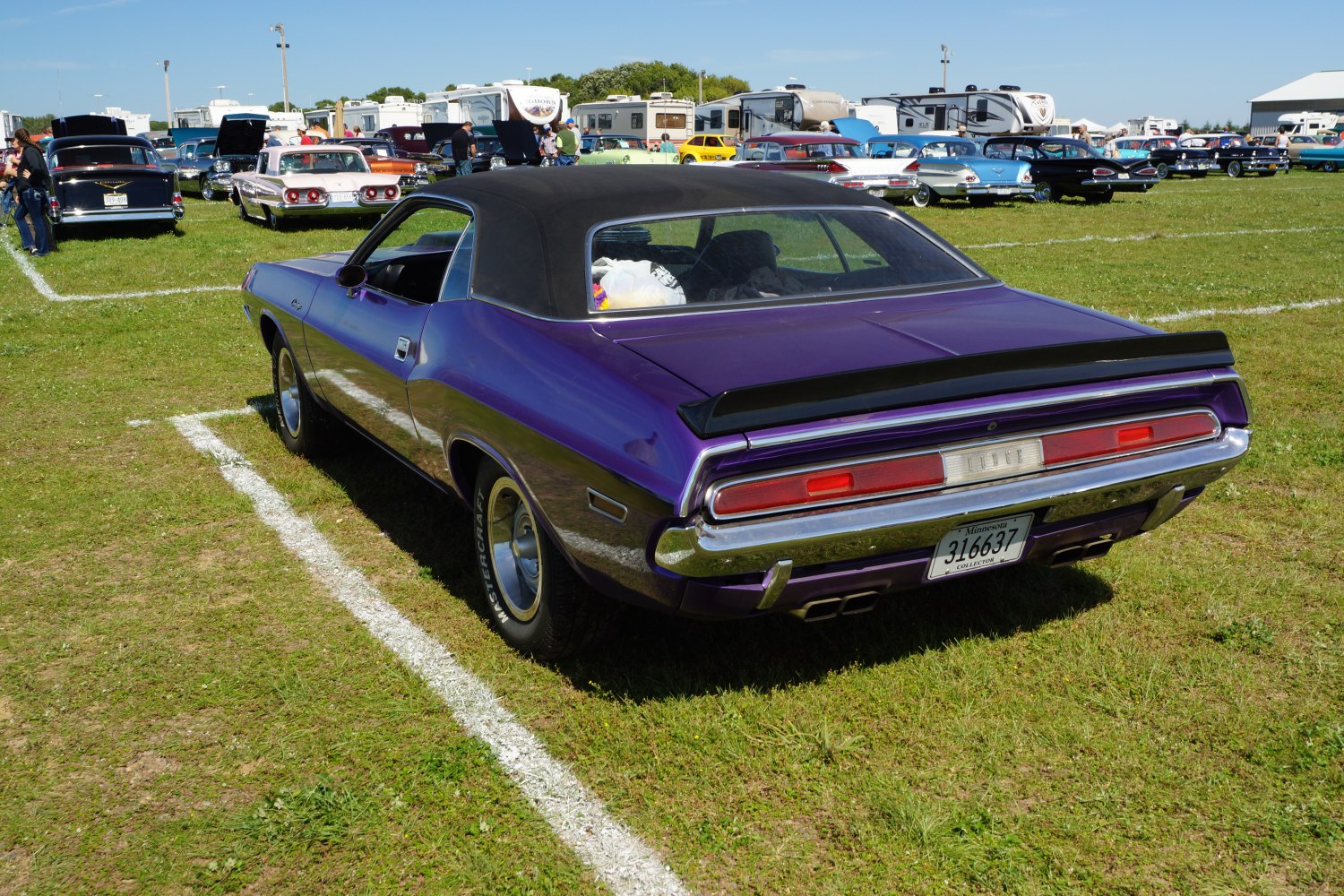 Rear view of vintage muscle car with black vinyl roof and distinctive tail lights