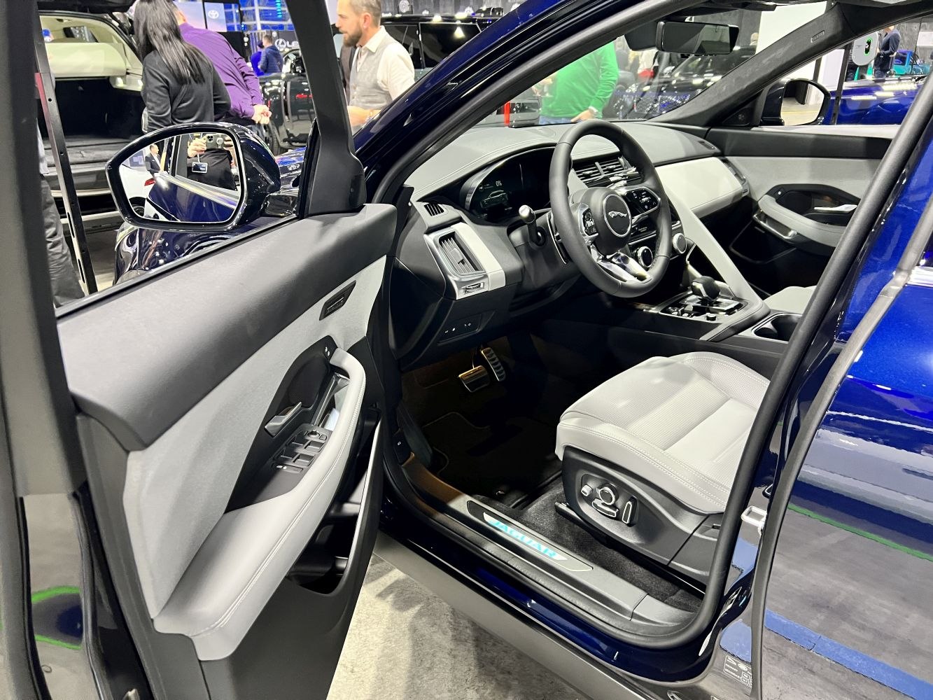 Luxury SUV driver cockpit with detailed door panel and power seat controls