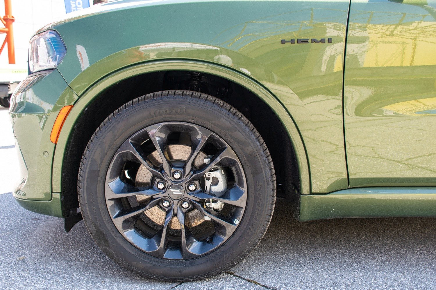 Close-up of black alloy wheel and front fender with HEMI badge