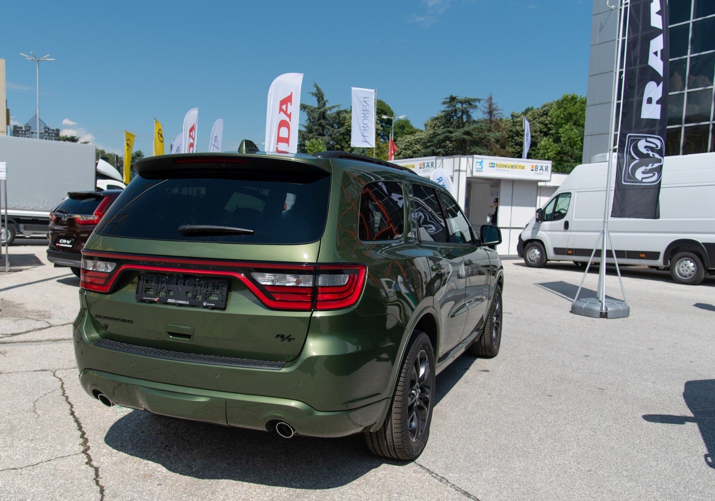 Rear view of green SUV with LED taillights and dual exhaust