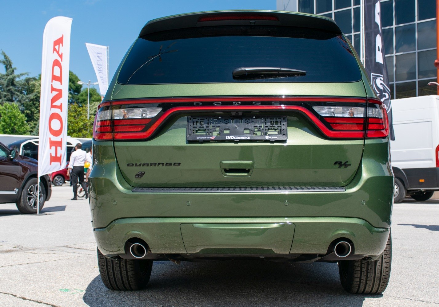 Green SUV rear with integrated taillights and twin exhaust pipes