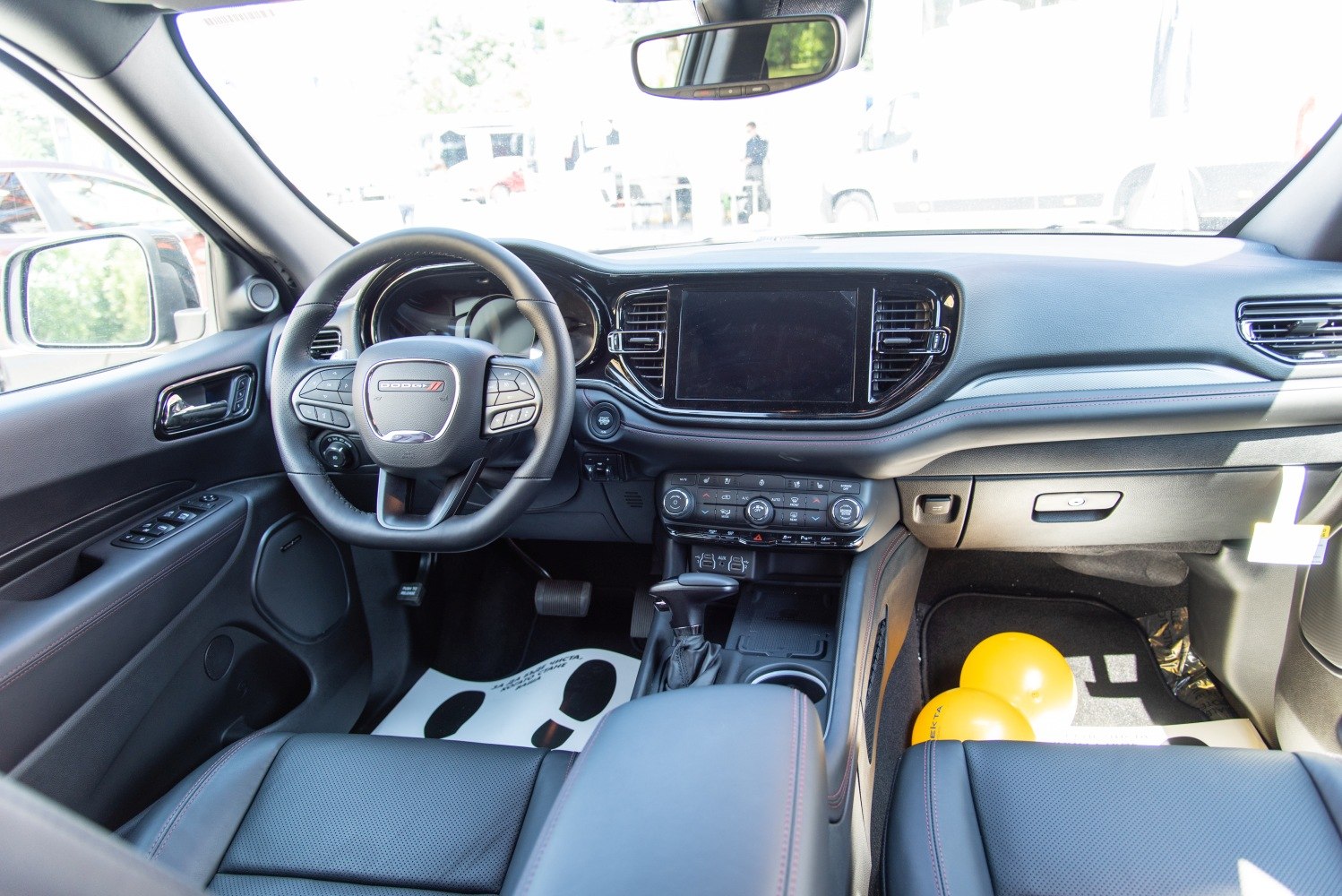 Modern SUV interior with dashboard, touchscreen, and multifunction steering wheel