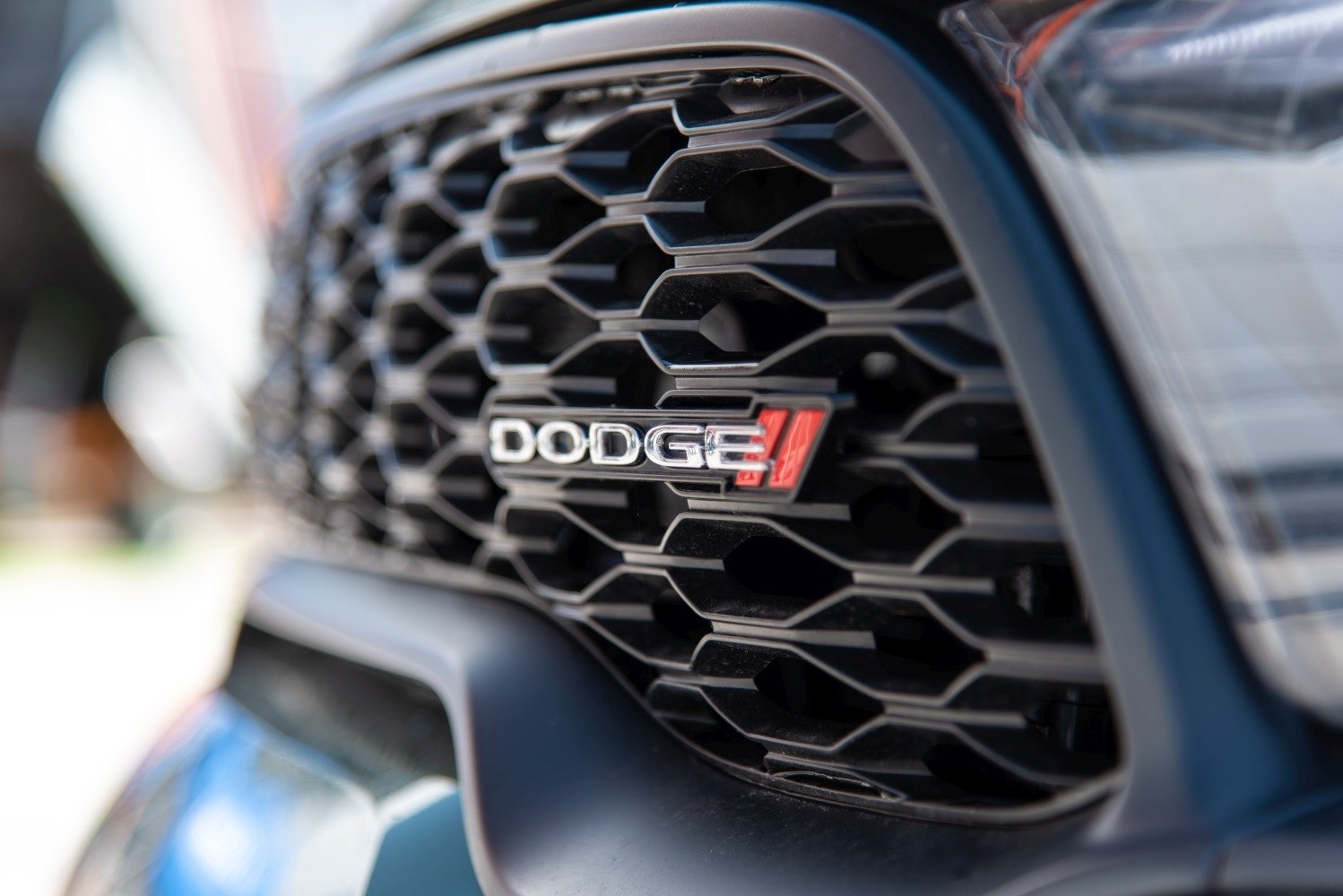 Black honeycomb pattern front grille with Dodge emblem