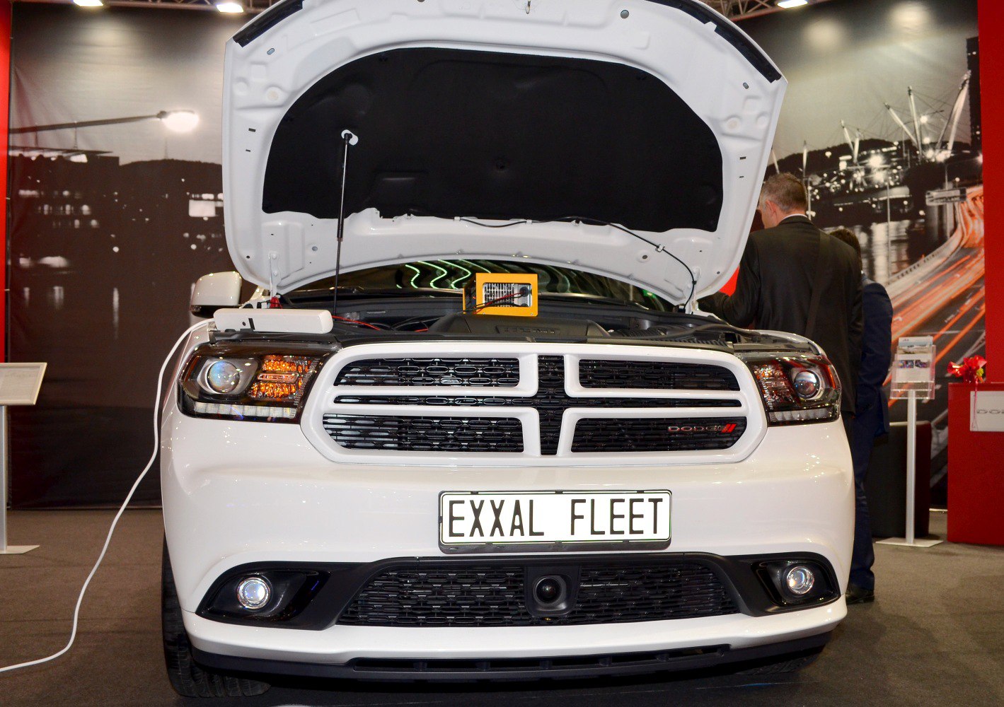 Front view of SUV with grille, headlights, and open hood