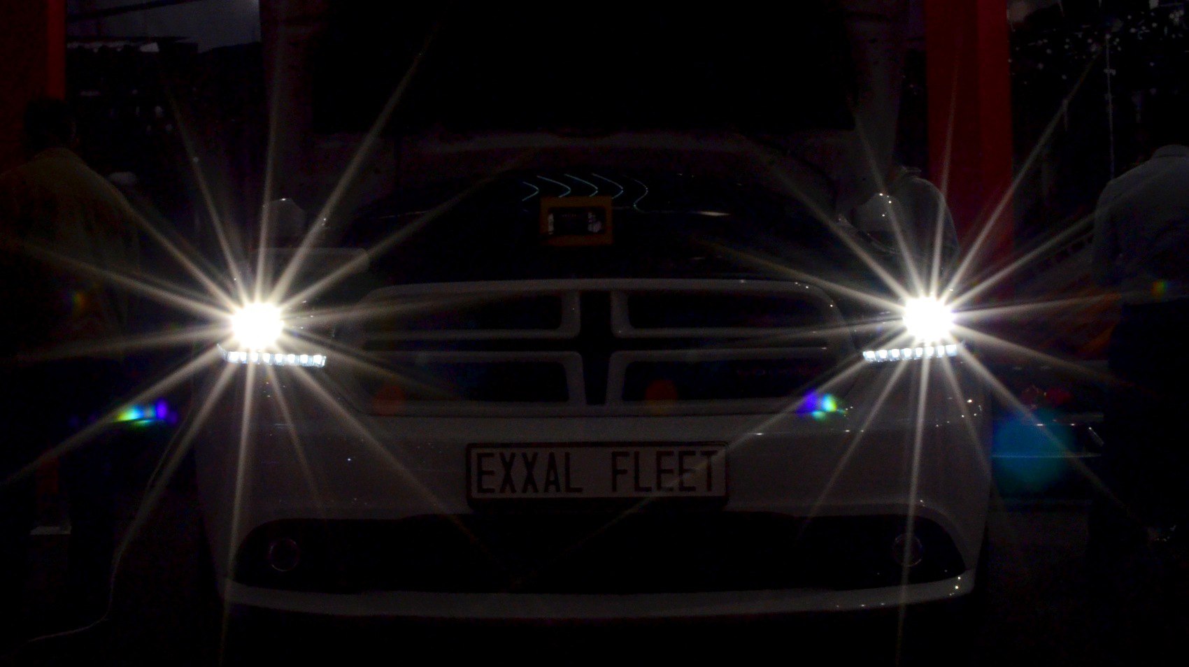 Front view with bright headlights and distinct grille