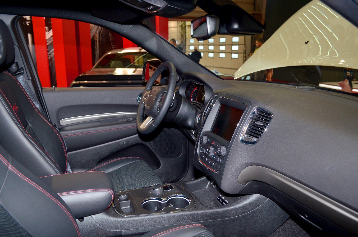 Dashboard, steering wheel, touchscreen, front seats with red stitching