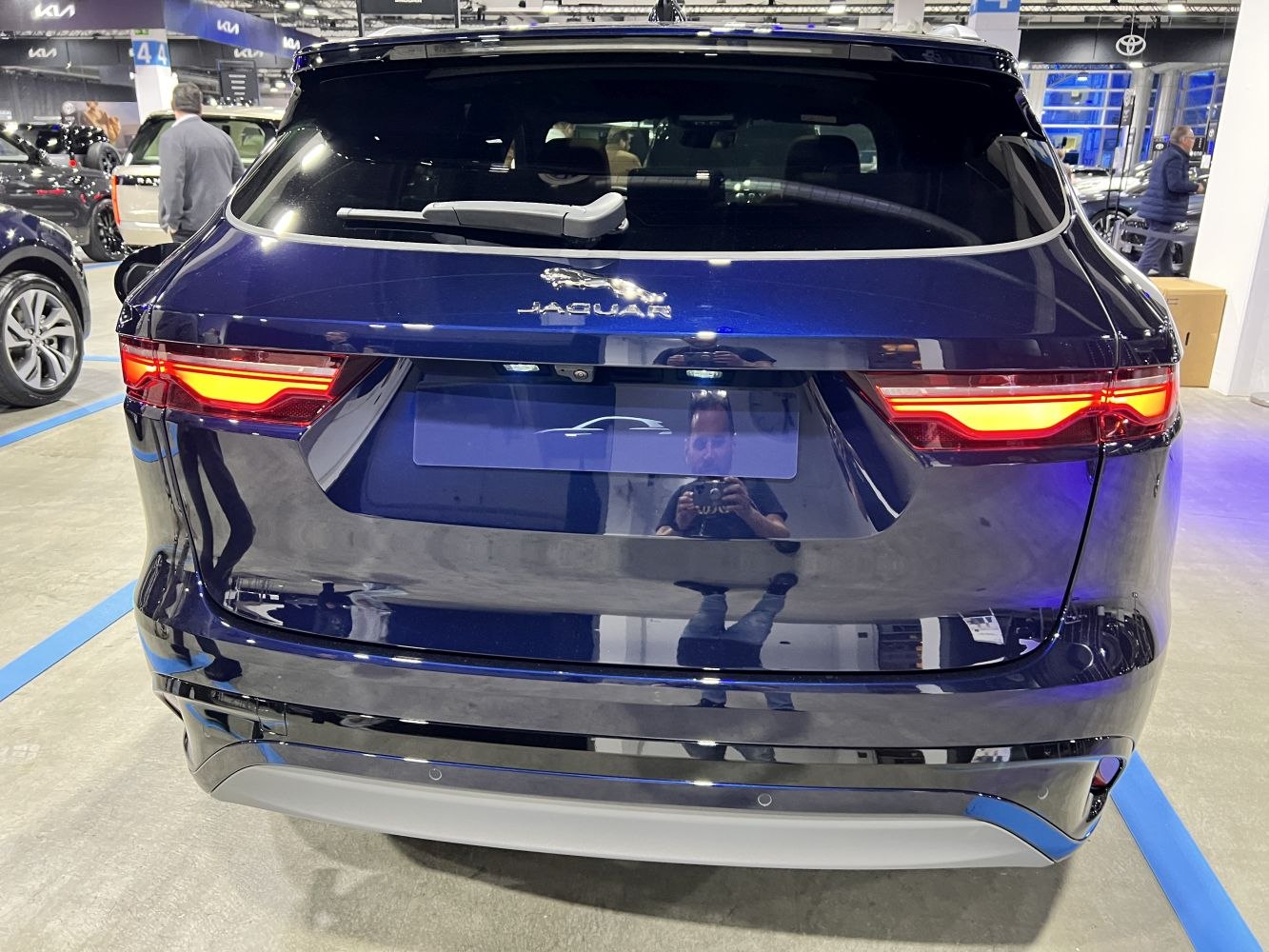 Rear view showcasing illuminated taillights and rear windshield wiper