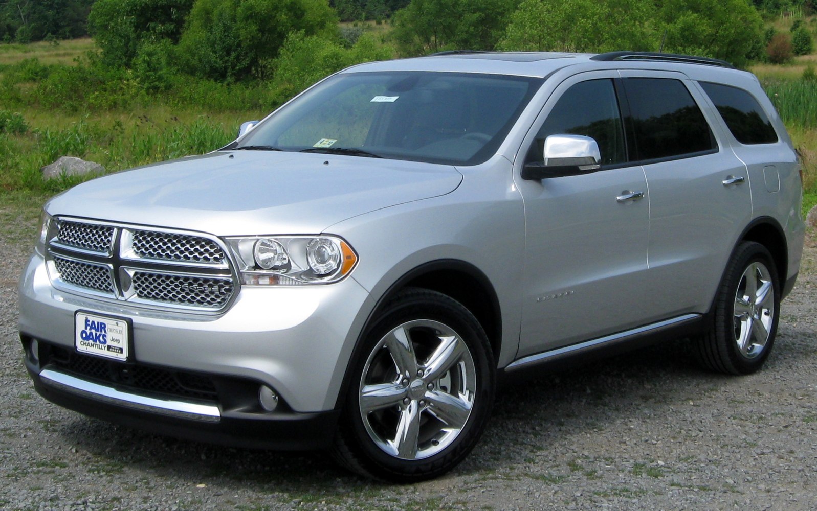 Silver SUV with chrome mesh grille and polished alloy wheels