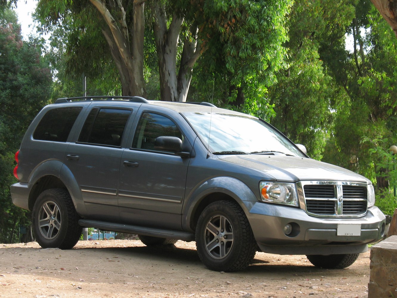 SUV side view with chrome grille and rugged tires
