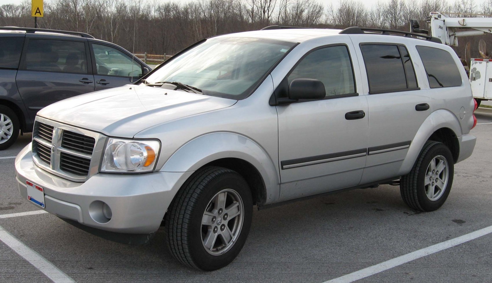 Mid-size SUV with silver paint, alloy wheels, roof rails, and tinted windows